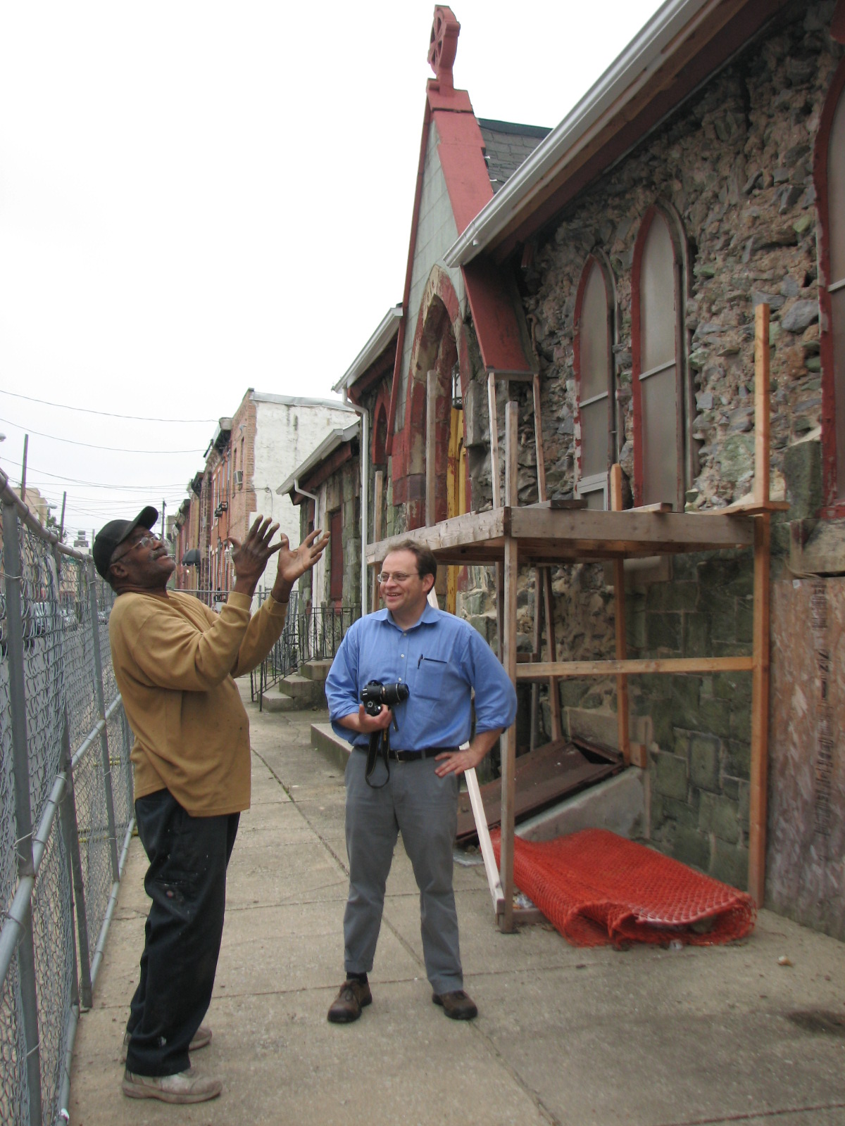 Lloyd Butler (left) and Aaron Wunsch discuss the restoration of the Titan Street side of the church.
