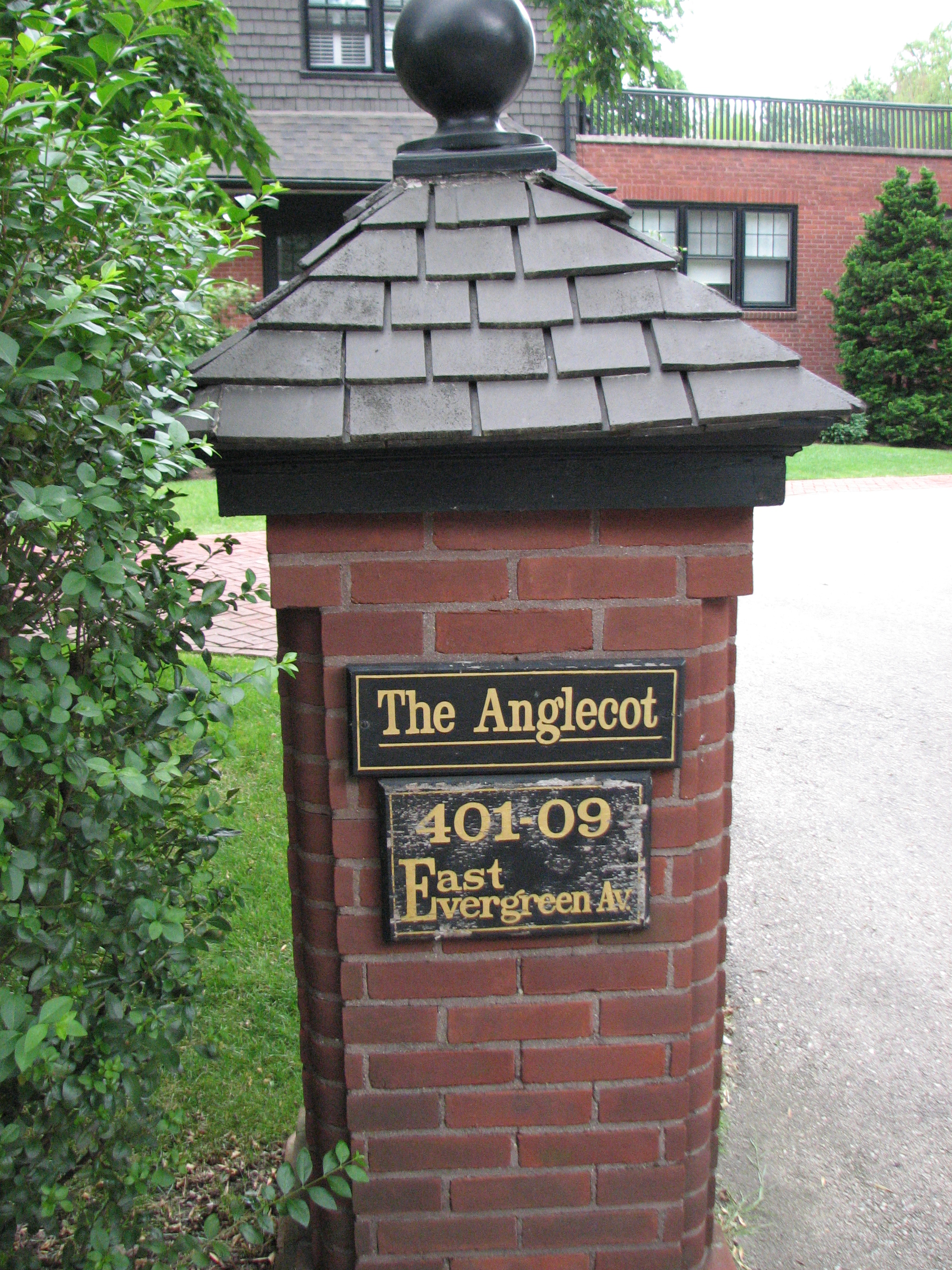 A brick and shingle column welcomes visitors to The Anglecot, 401 E. Evergreen Ave.