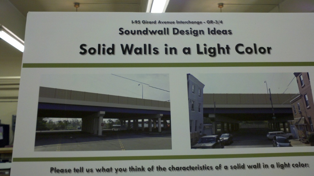 A solid, light-colored sound wall