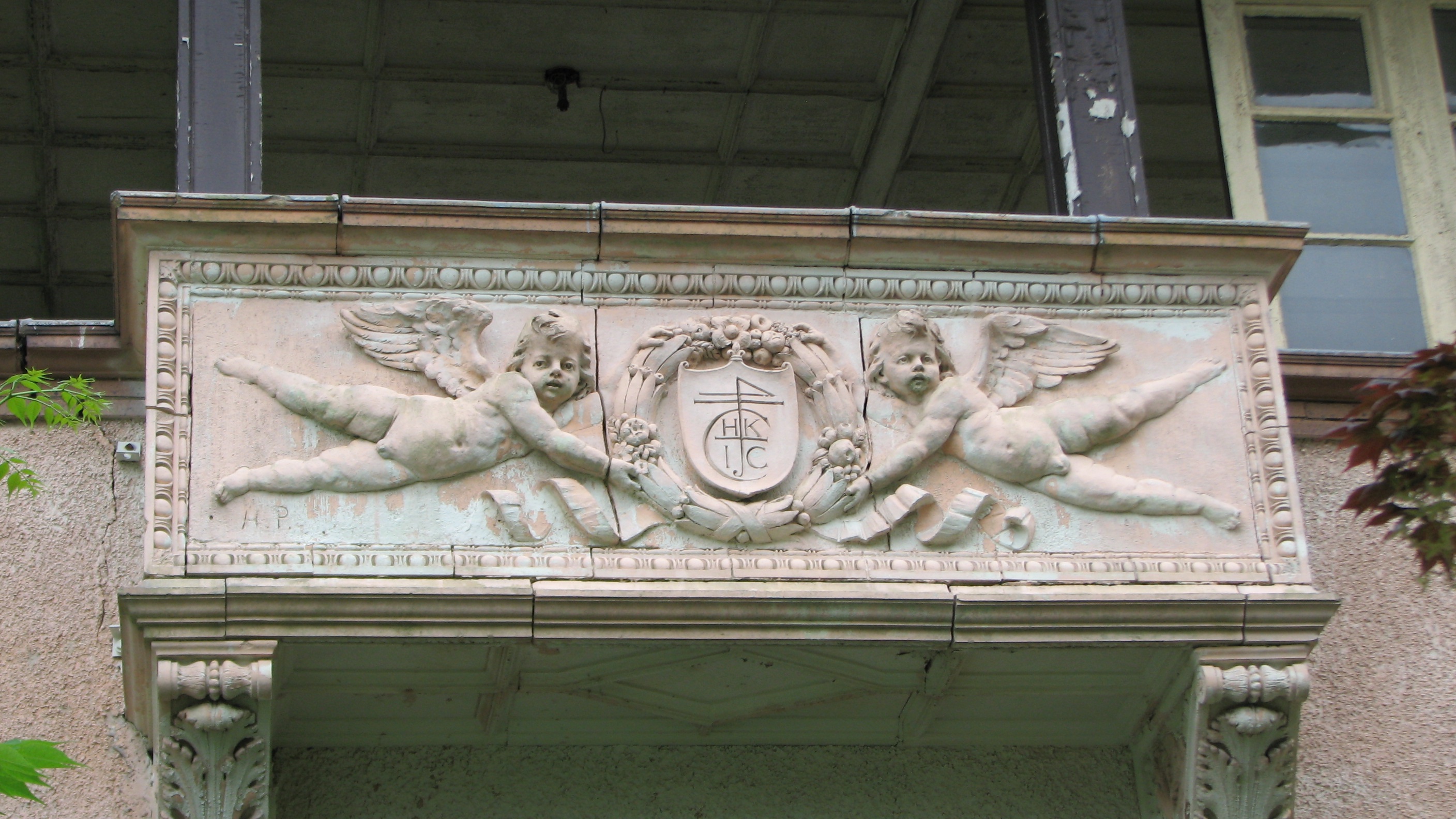 The carvings on the open loggia include the initial of the home’s original owner.