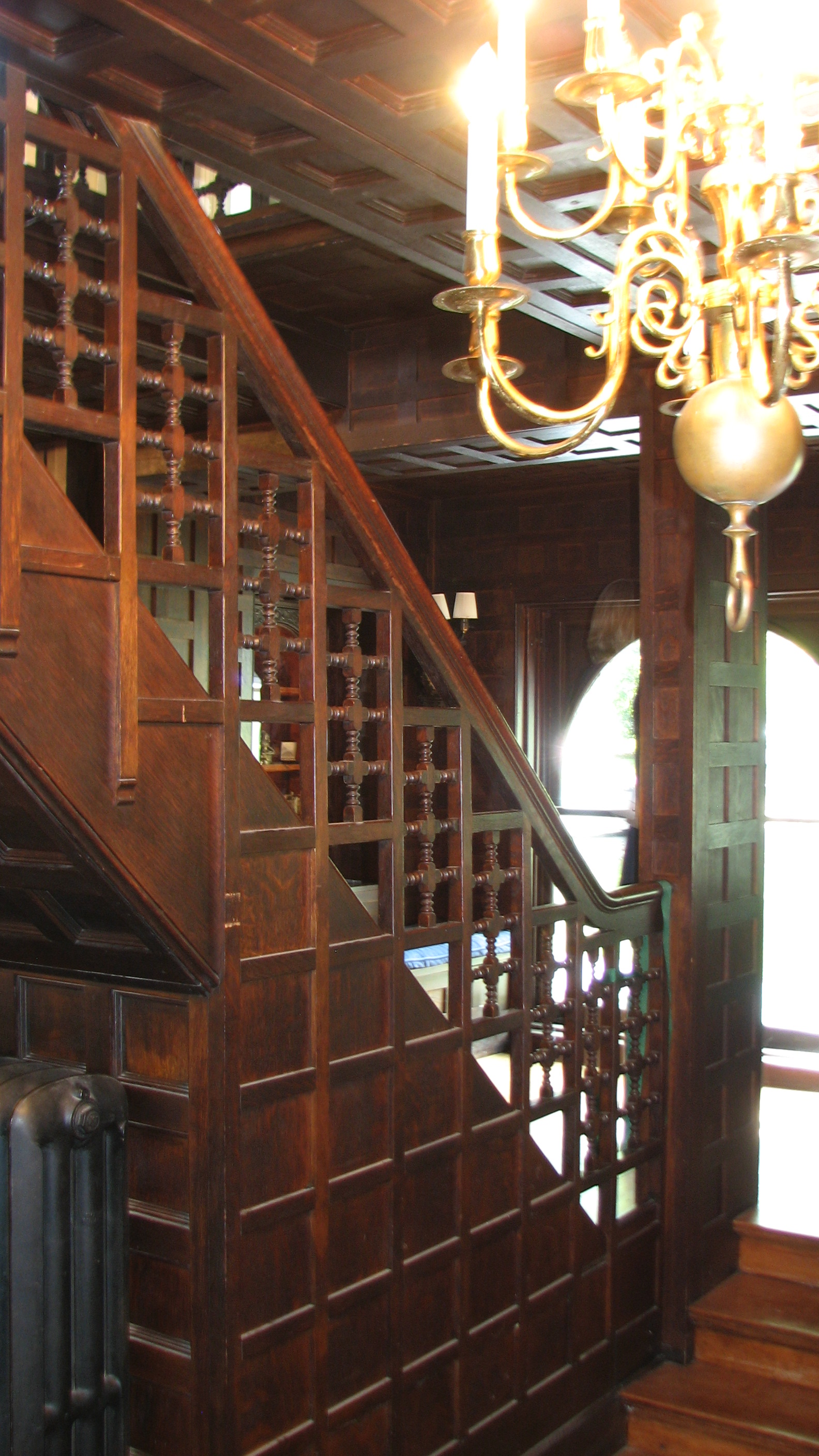 Interior details include a grand staircase and carved wood paneling