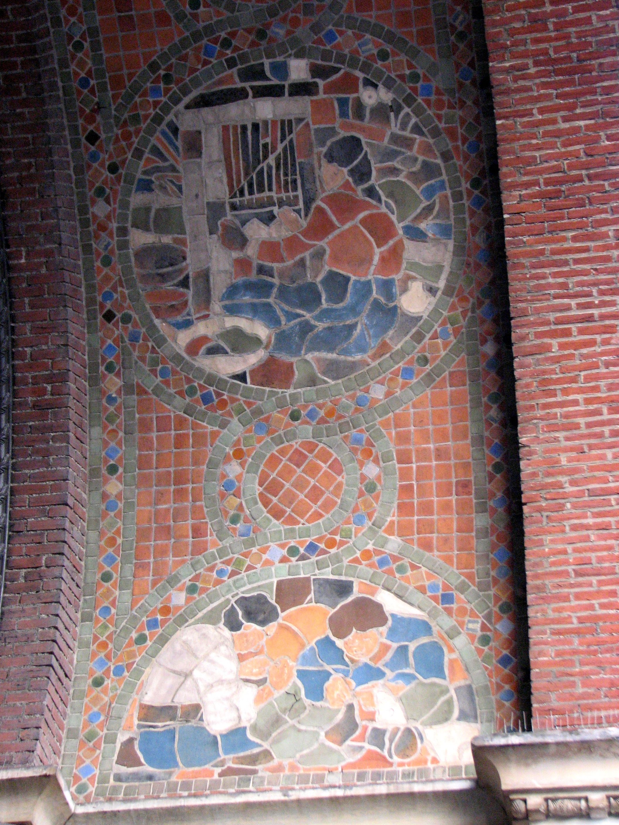 Mosaics of garment workers adorn the entry arch to the former clothing store.