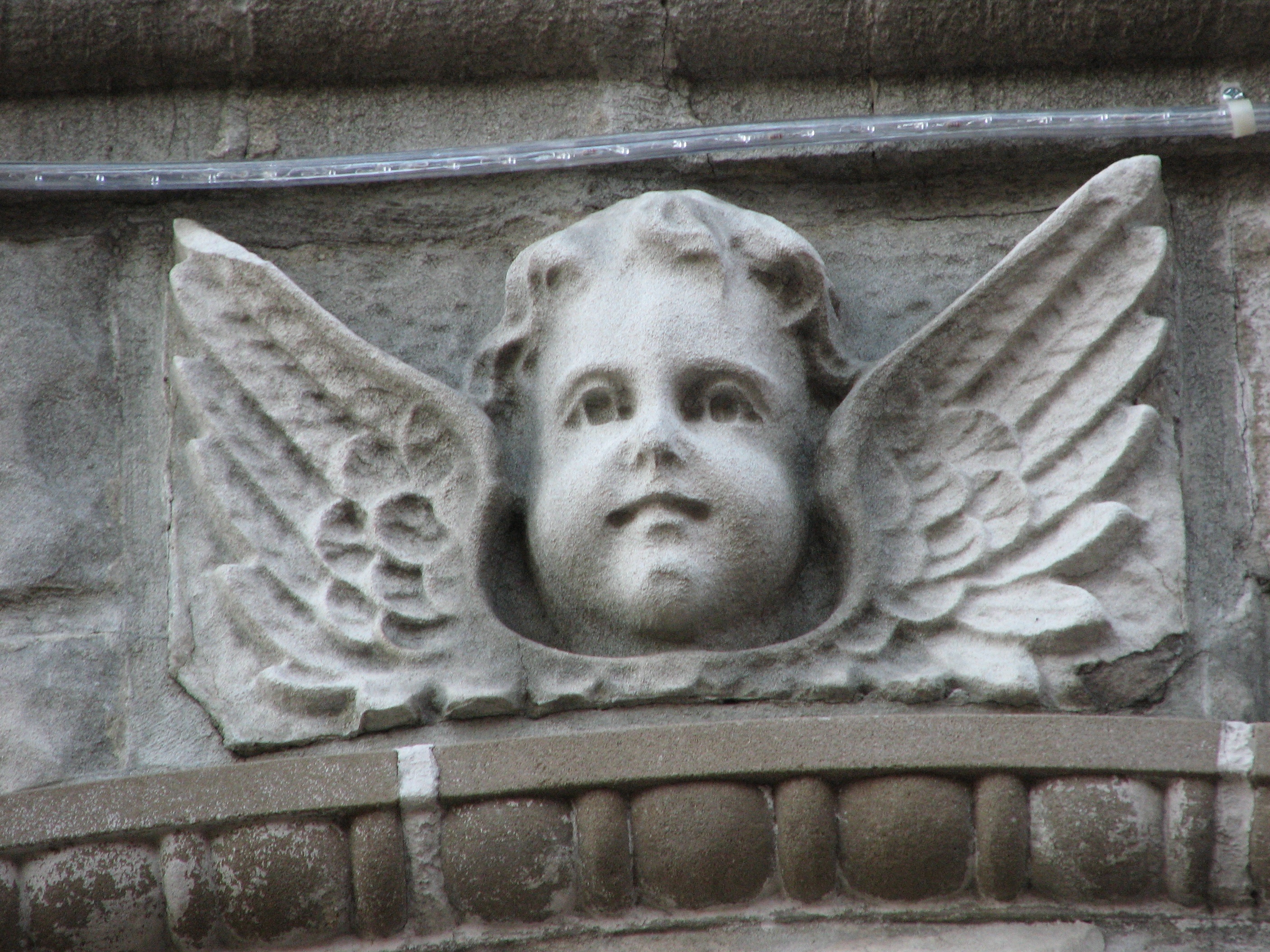 An angelic face above the entrance to the Ronald McDonald House.