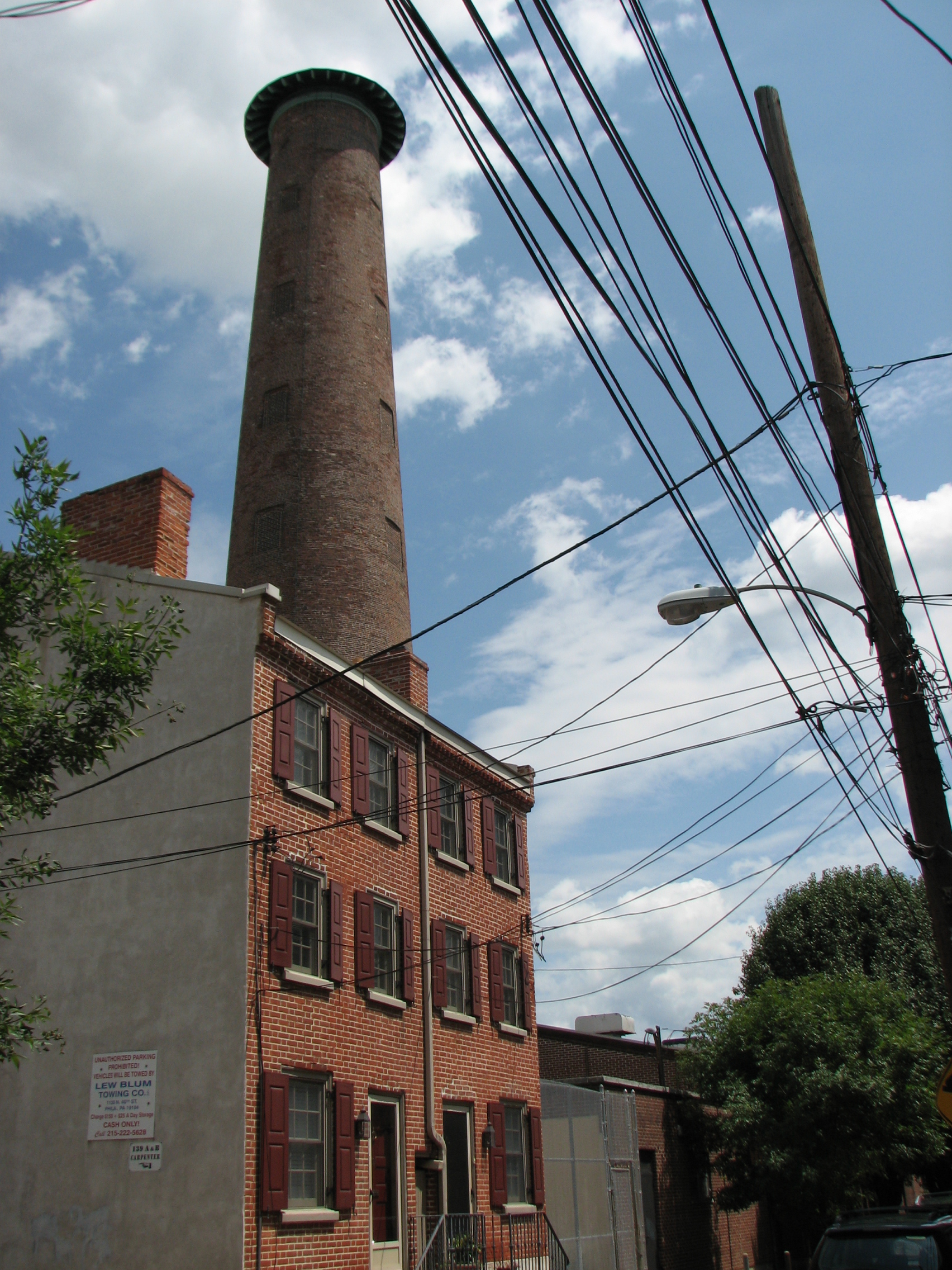 The Sparks Shot Tower looks down on 19th century homes and 20th century wiring on narrow Carpenter Street.