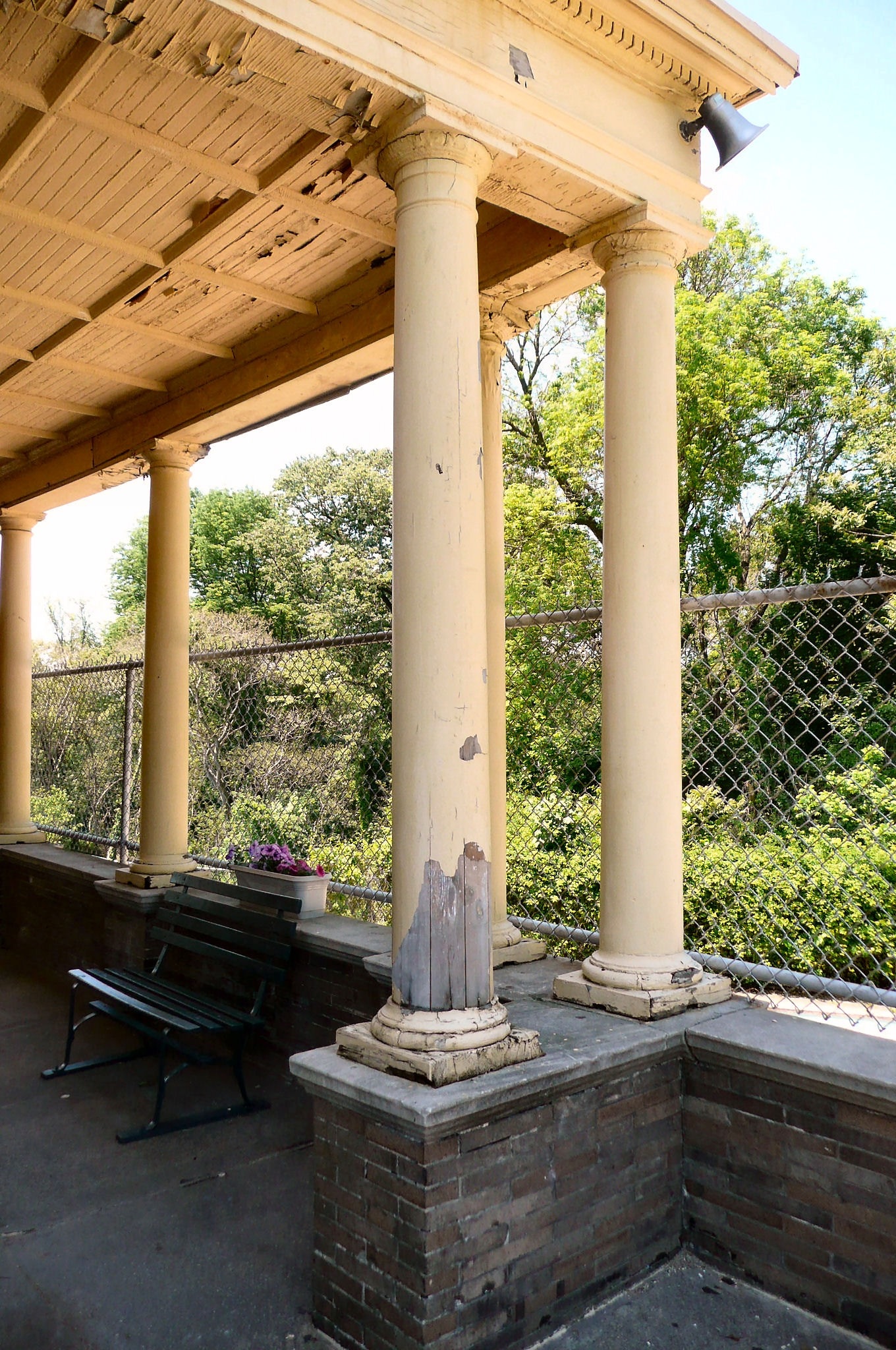 The columns and ceiling of the Smith Playhouse porch before restoration.