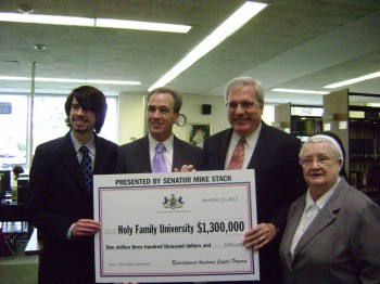 Sen. Stack (second from left) presents a $1.3 million grant to Holy Family University. With him are (L to R) Holy Family student Matthew Reese, Associate Professor of Political Science Dr. Stephen Med