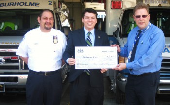 Responder Lou Maldonaldo (L) and BEMS Managing Director Tim Hinchcliff (R) accept a check from Rep. Brendan Boyle and the state. Photo/G.E. Reutter