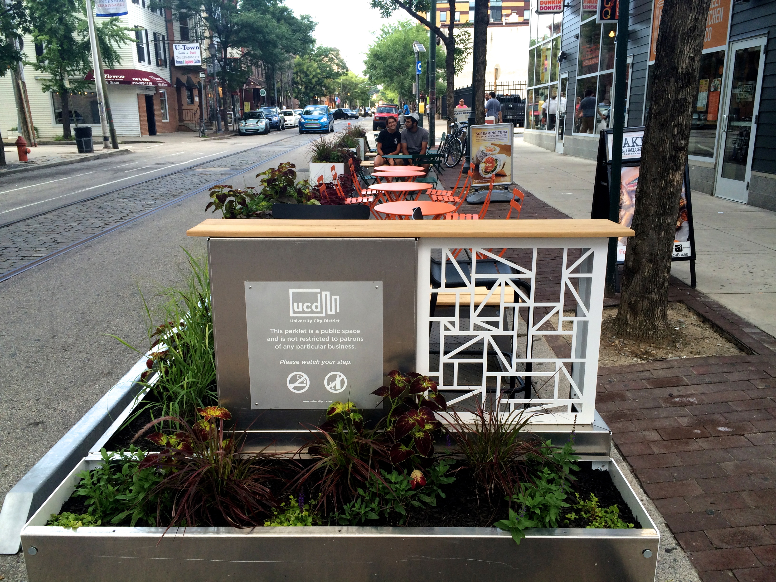 Planters ring the parklet creating a beautified buffer to separate the space from street traffic