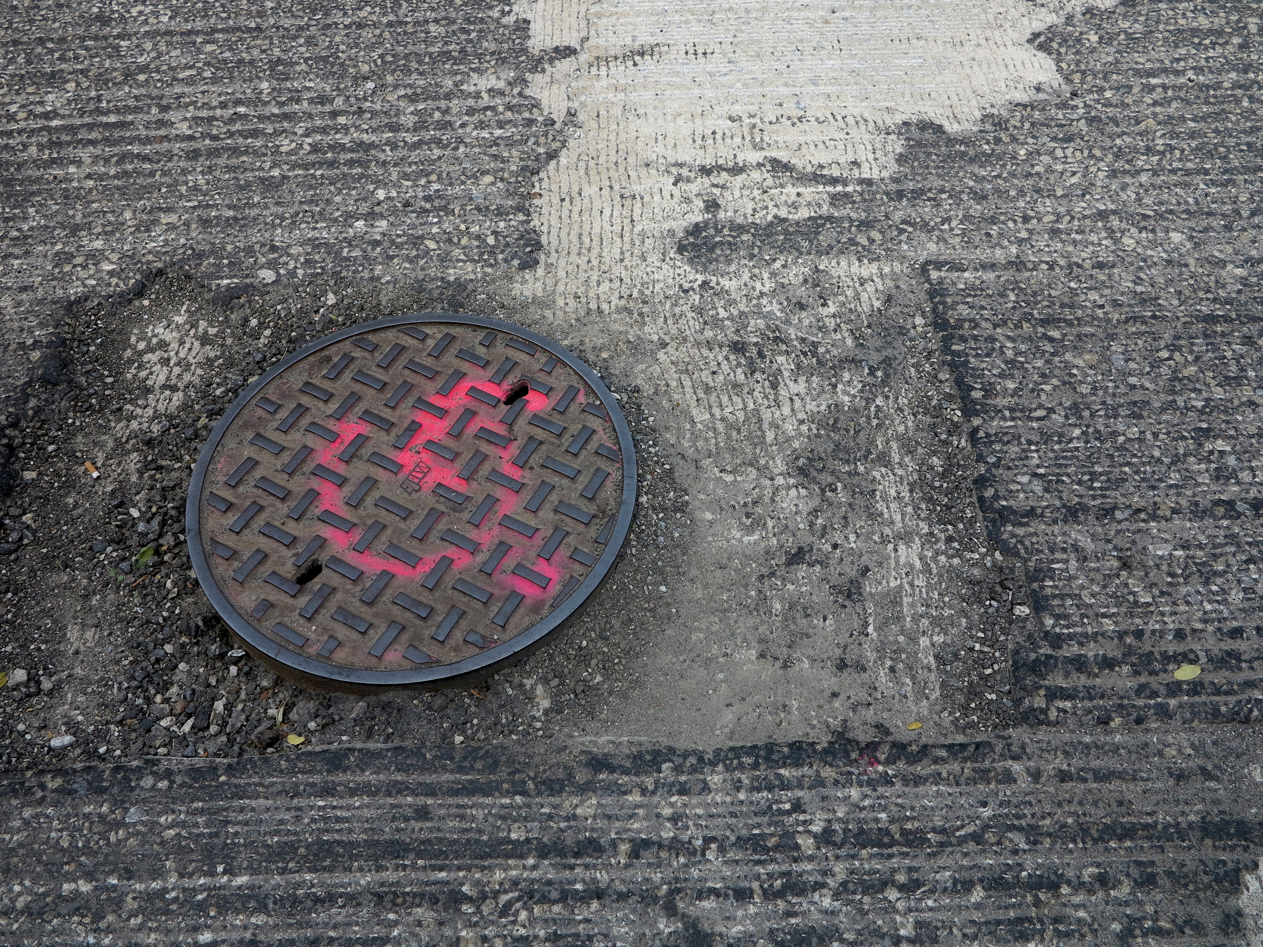 Manhole covers will be reset before resurfacing.