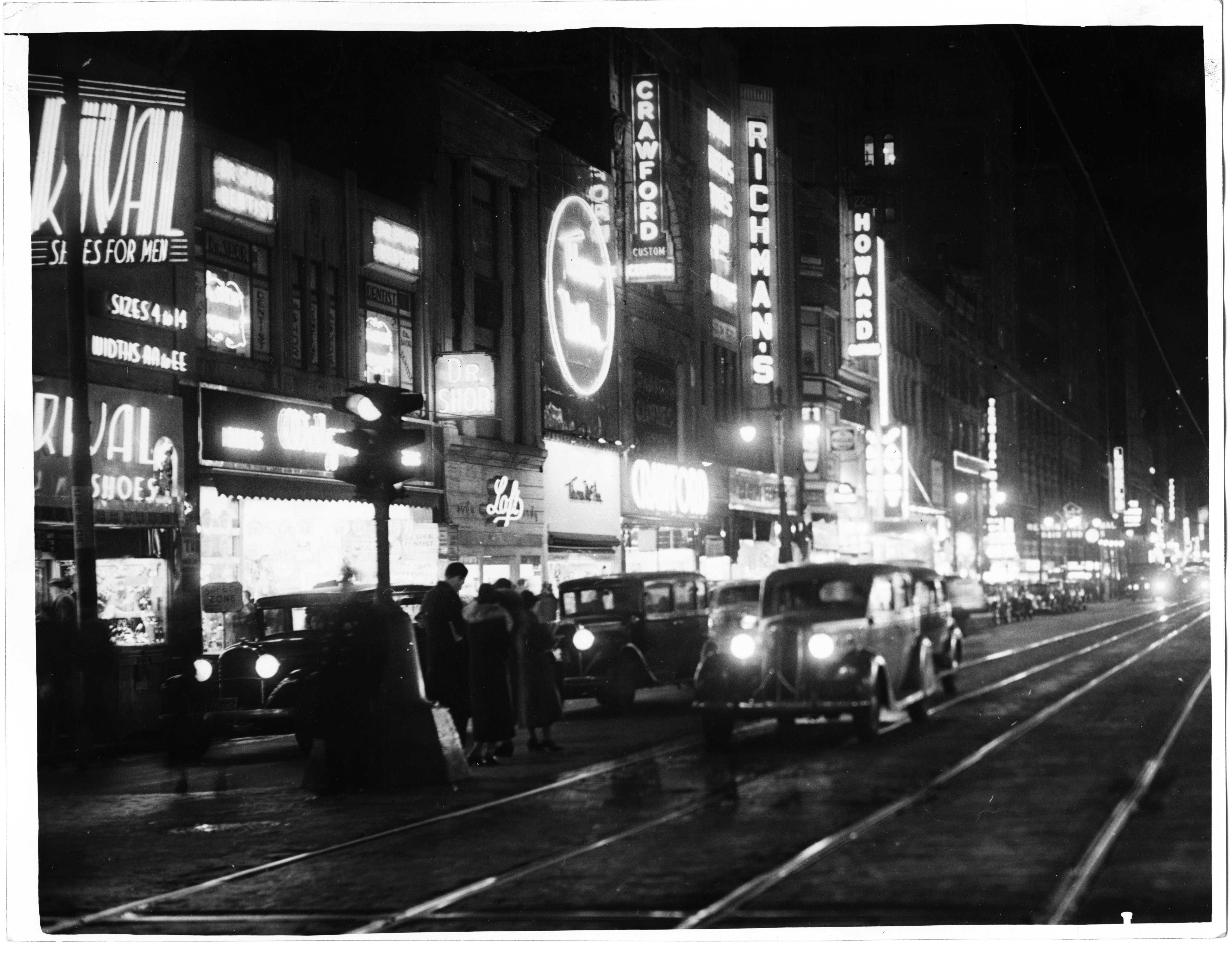 Record Number: 744Collection: Philadelphia Record Photograph Morgue[V07]Folder Number: FF 3011Reproduction restrictions: UnknownAddress: 1239 Market StreetPhiladelphia, PA 19107, USADate of Original: February 3 1938Image description: Photograph depicts Market Street at night looking east from 13th Street, showing N. side of street.