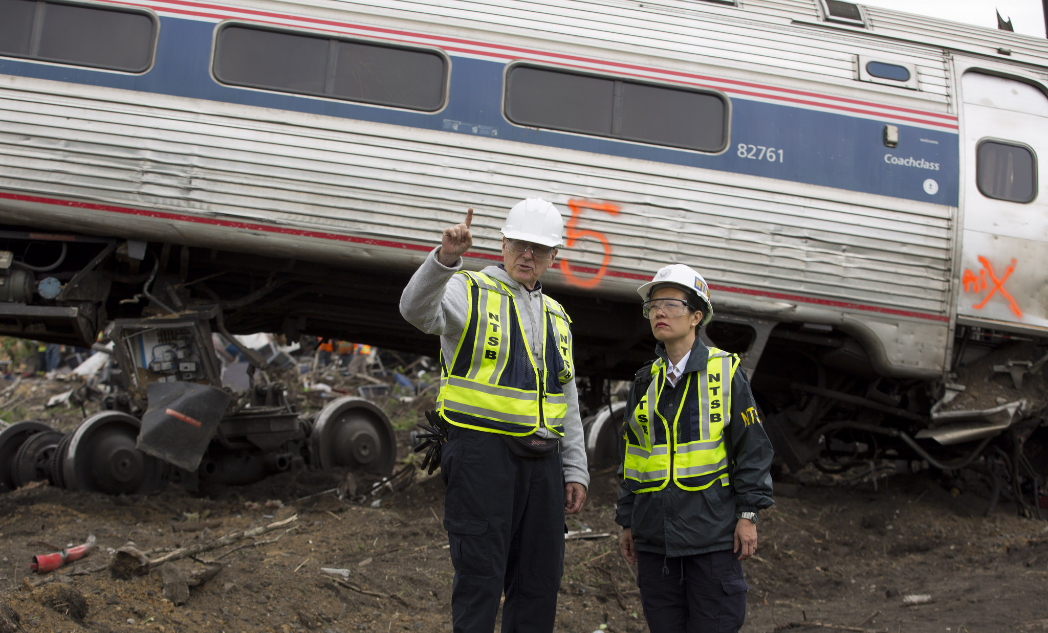 NTSB IIC Mike Flanigon briefs Vice Chairman Dinh-Zarr on the scene of the Amtrak Train #188 Derailment in Philadelphia, PA | NTSB, Creative Commons NTSB IIC Mike Flanigon briefs Vice Chairman Dinh-Zarr on the scene of the Amtrak Train #188 Derailment in Philadelphia, PA | NTSB, Creative Commons
