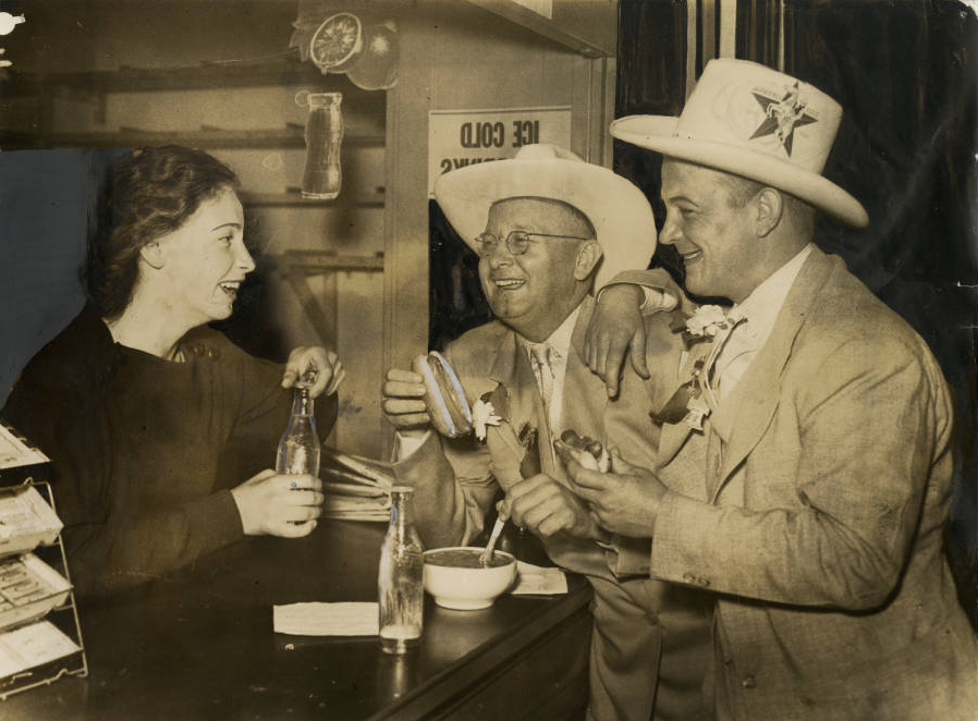 Beatrice Zippel,of 1932 South Third Street, serves lunch to Earle B. Mayfield Jr., and State Senator Thomas G. Pollard, of Texas. | Philadelphia, June 25, 1936 | Evening Bulletin | Special Collections Research Center, Temple University Libraries, Philadelphia, PA 