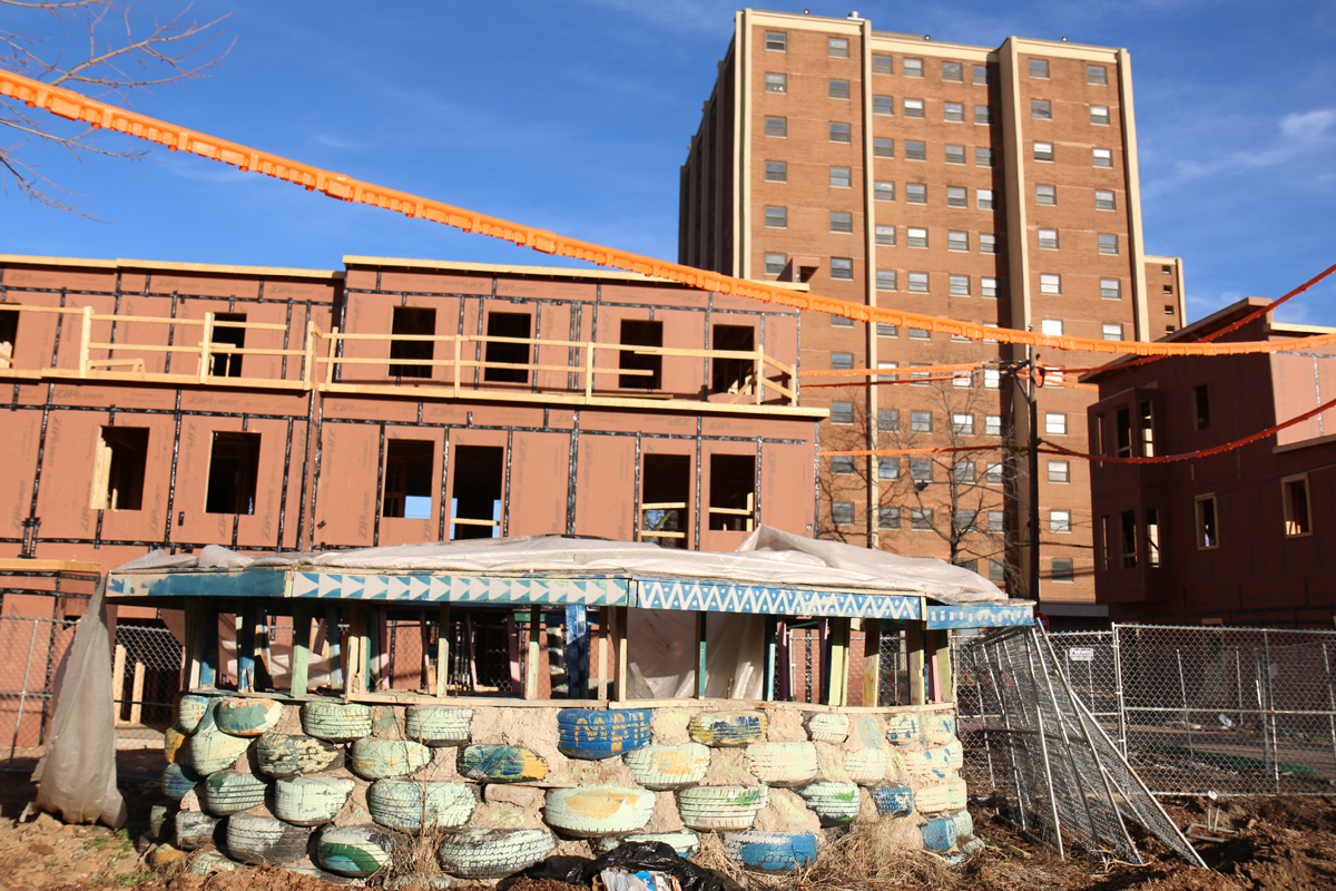 This spring, the Peace Park's schoolhouse still stood behind the agency's new apartments and in the shadow of the public housing towers. (Marielle Segarra/WHYY)