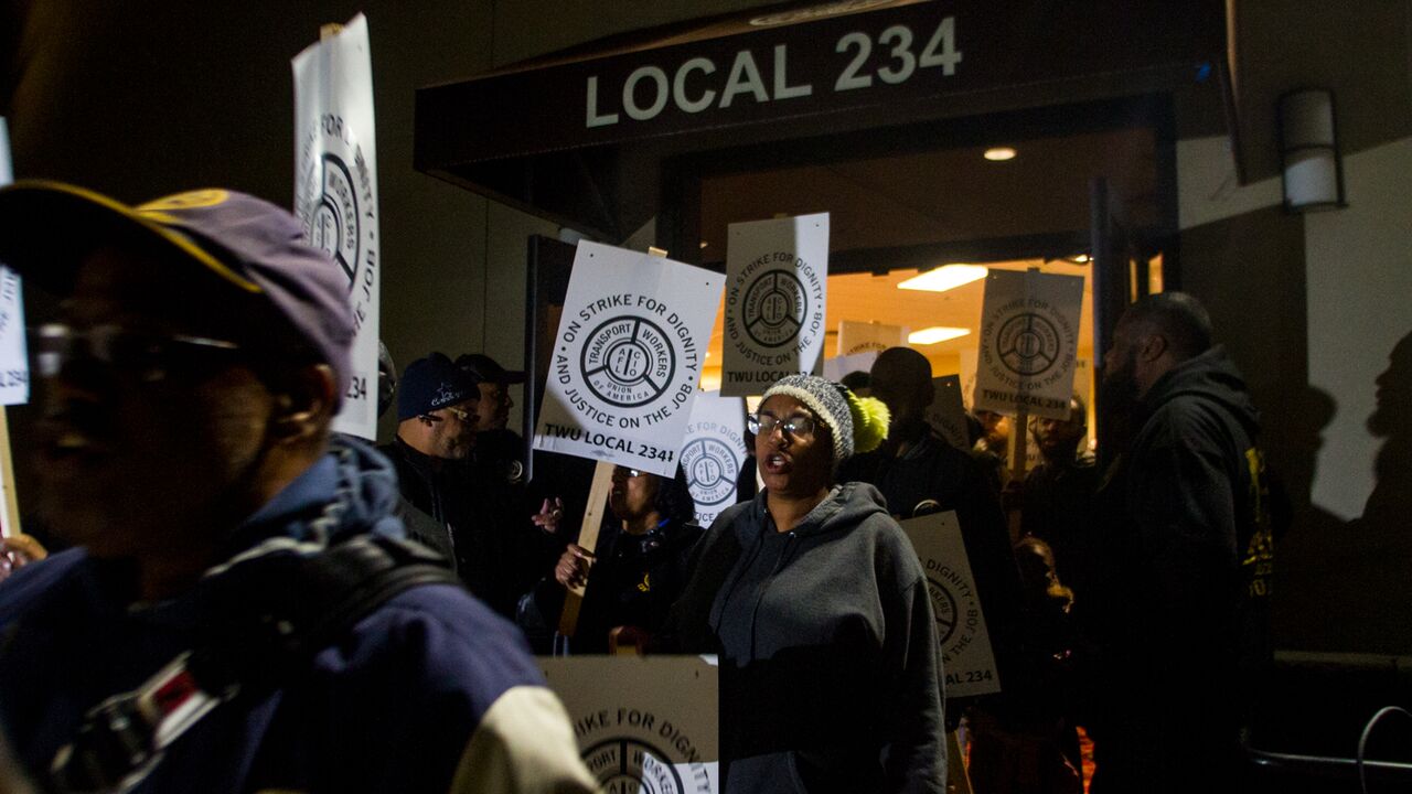 TWU Local 234 workers rally Friday night and distribute strike signs for the picket lines (Brad Larrison for WHYY)