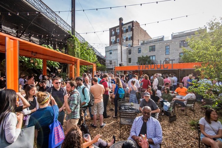 A popup beer garden created on a lot beneath the Reading Viaduct for Philadelphia's Rail Park in 2016. (Hood Studio)