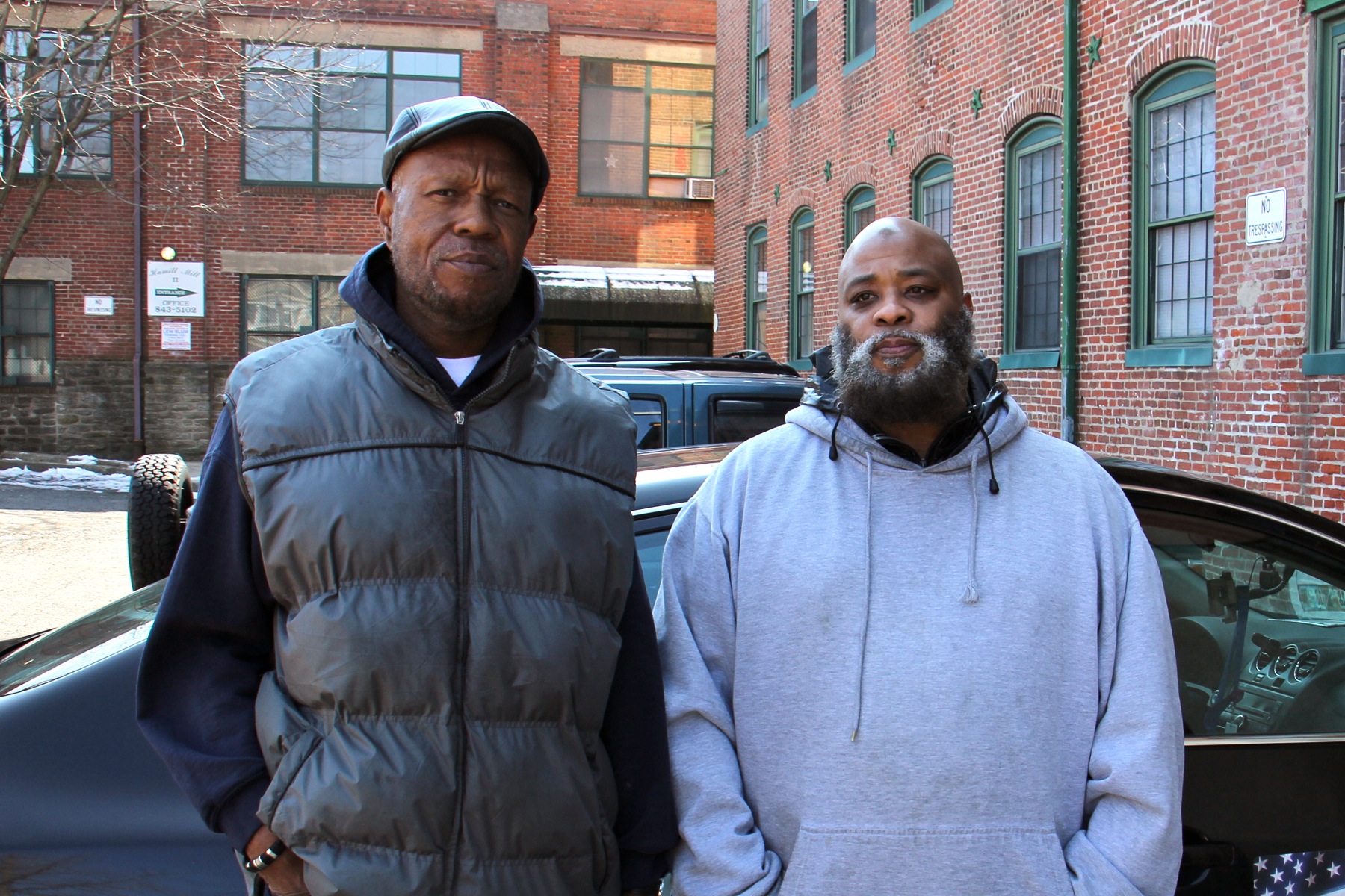 Brothers Tony Pointer (left) and Leroy Prince live in the Hamill Mill II apartments. Prince says he has to heat water on his stove for bathing. (Emma Lee/WHYY)