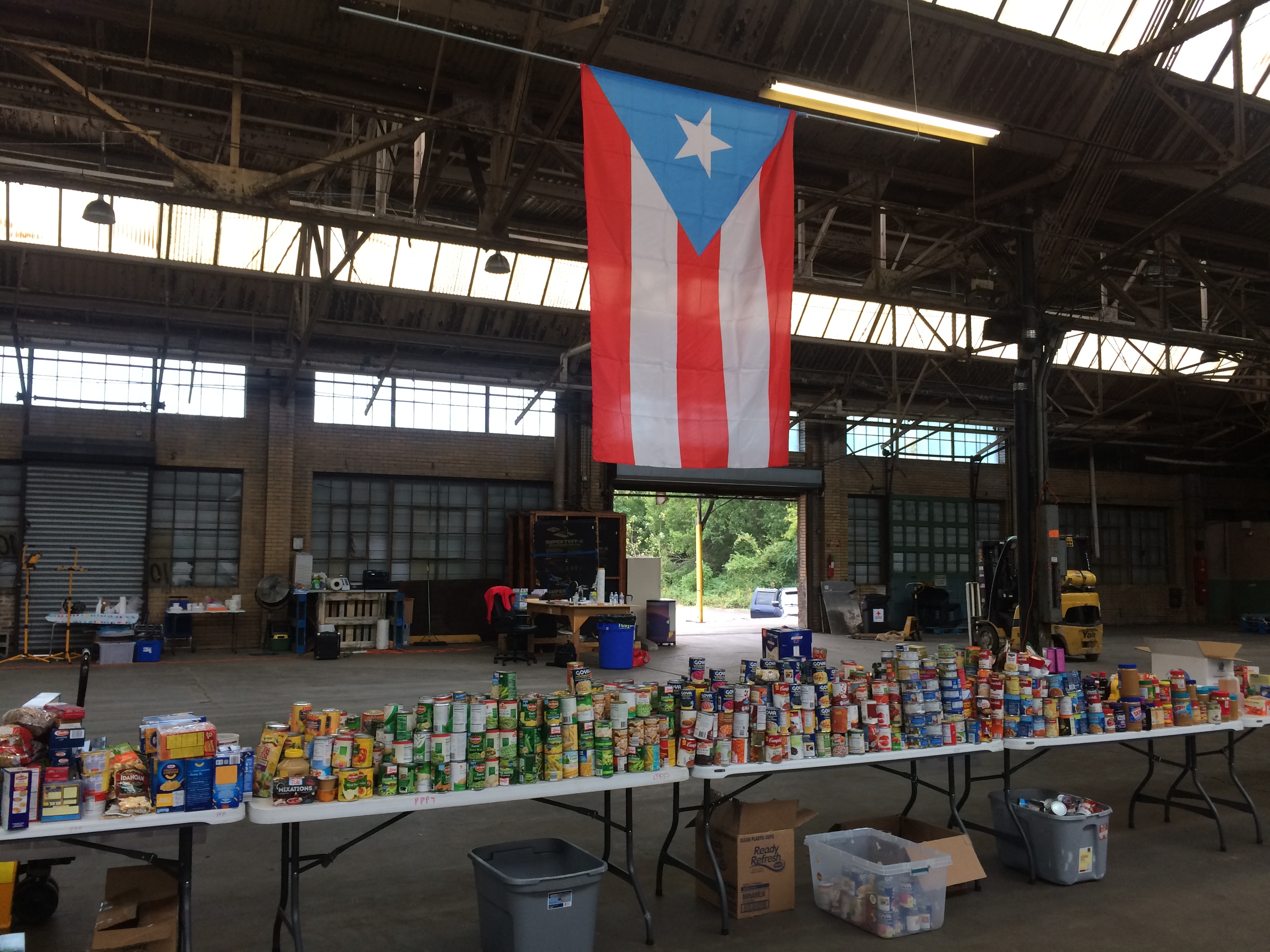 Food donations are sorted by volunteers at the Unidos Pa' PR warehouse at 956 East Erie Ave.