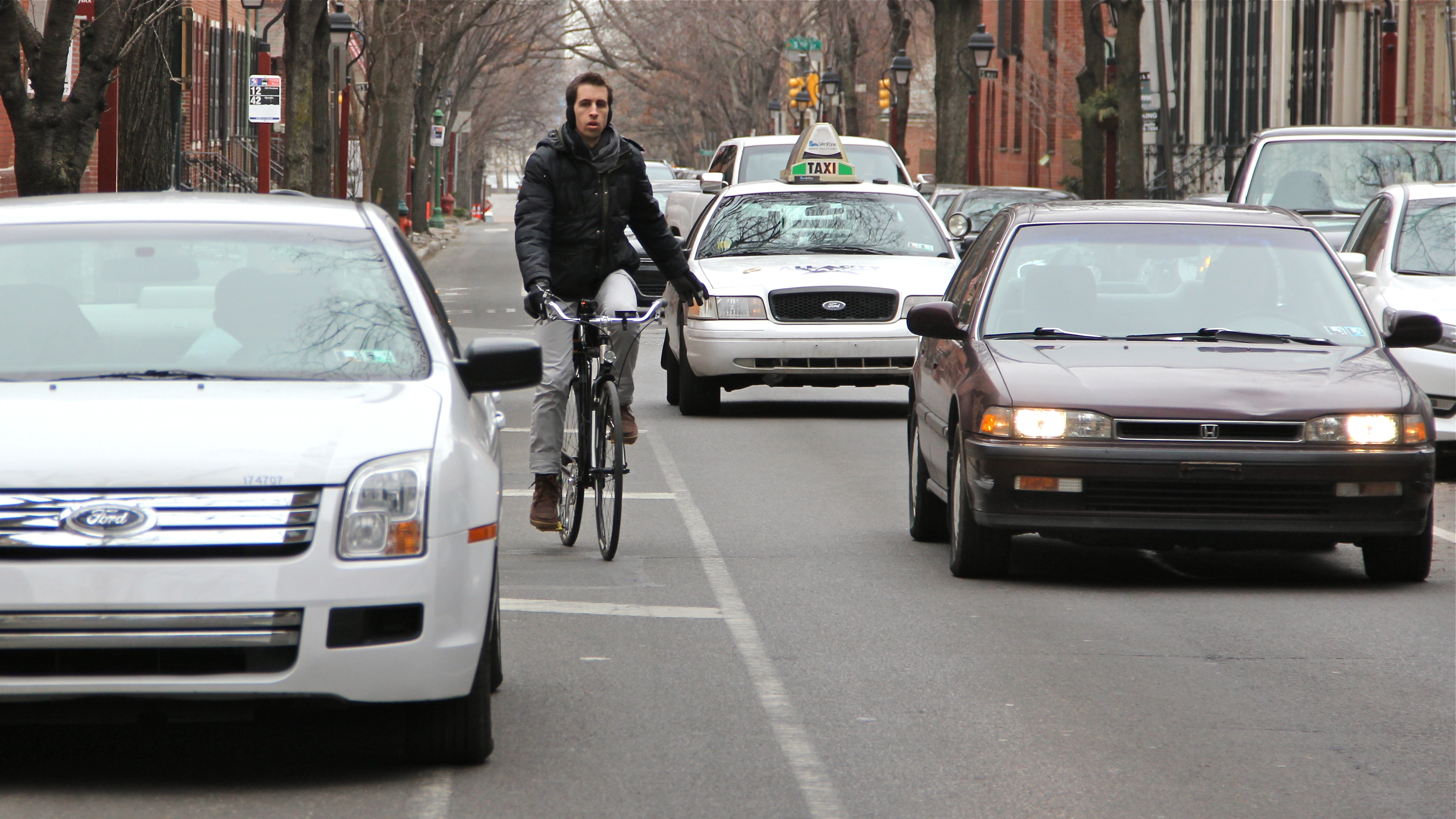 Cars and bikes compete on many Philadelphia streets despite bike lanes. 