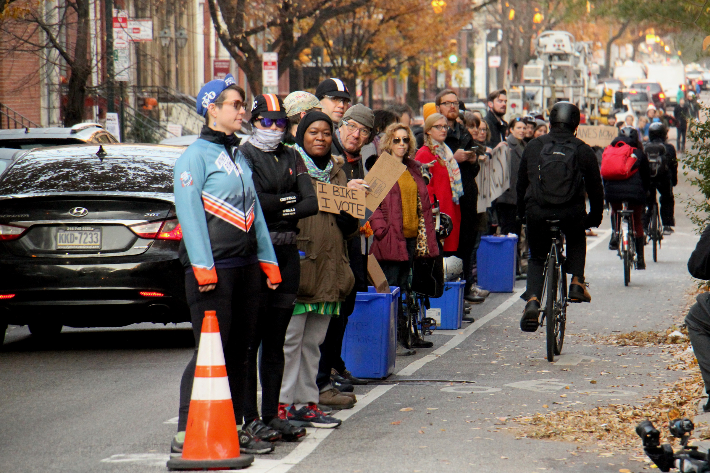 Cyclists form a human-protected bike lane along Spruce Street on Nov. 29, 2017, one day after Emily Fredricks was struck and killed on the street.