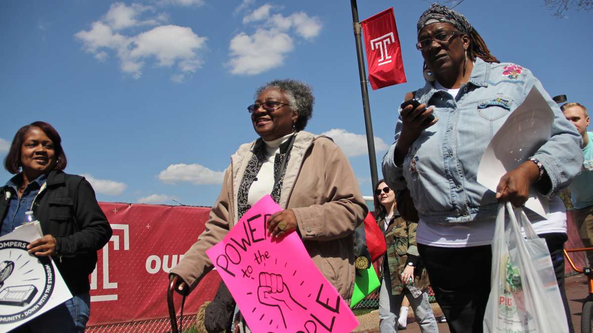 Jacqueline Wiggins (center), a long time resident of the Temple University area, joins neighbors and students in an April 2016 march against a proposed stadium. (Emma Lee/WHYY)