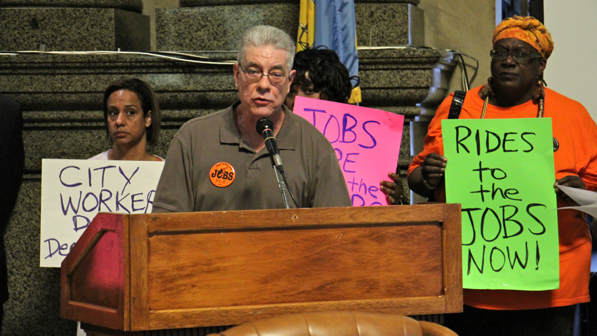 John Dodds, of the Philadelphia Unemployment Project, calls for reverse commute assistance for city residents during a press conference at City Hall. (Emma Lee/WHYY)