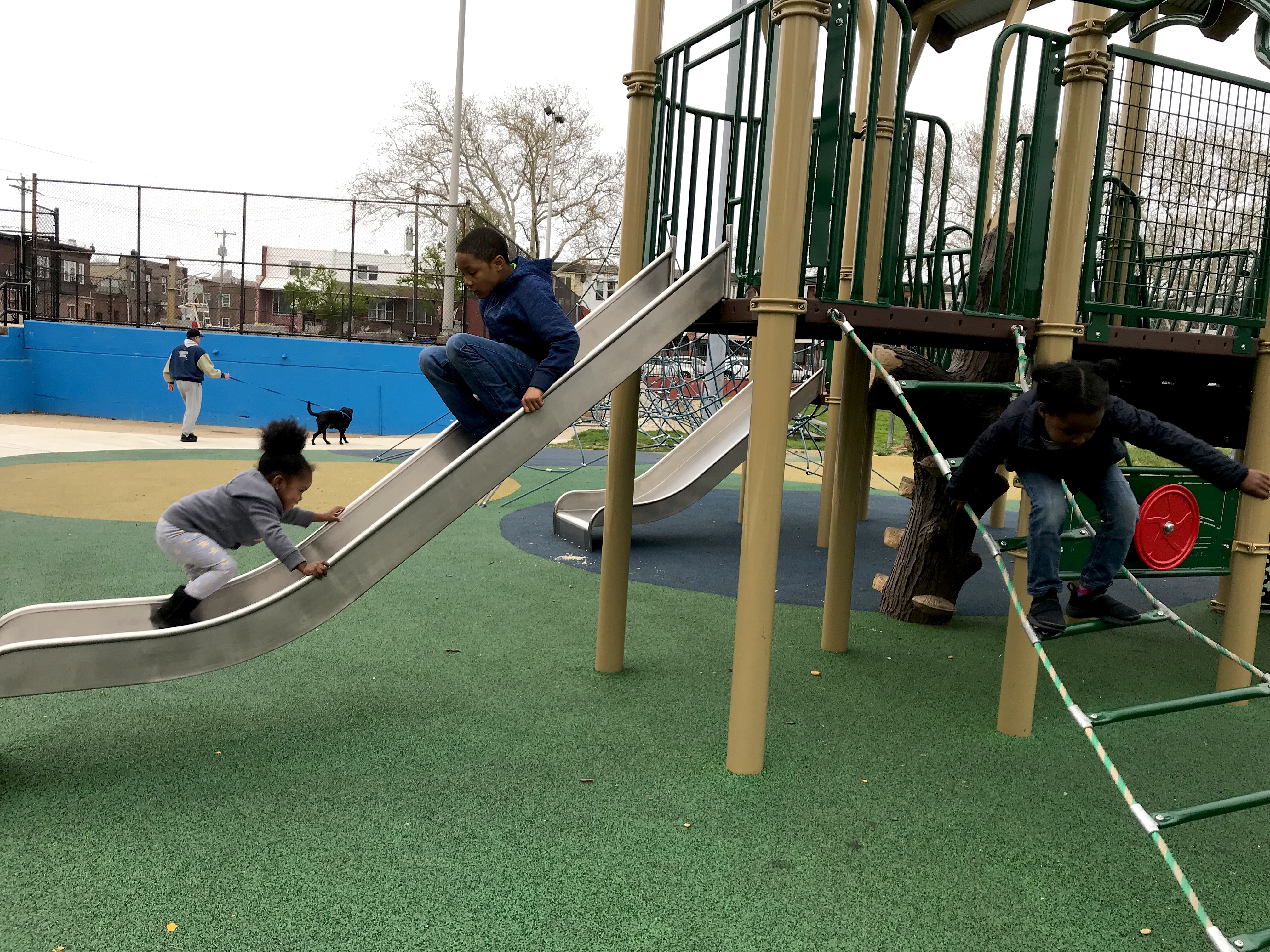 Lamaj Laws and Lauren Solomon play at an inclusive playground at Murphy Rec Center. (Ariella Cohen/ WHYY)