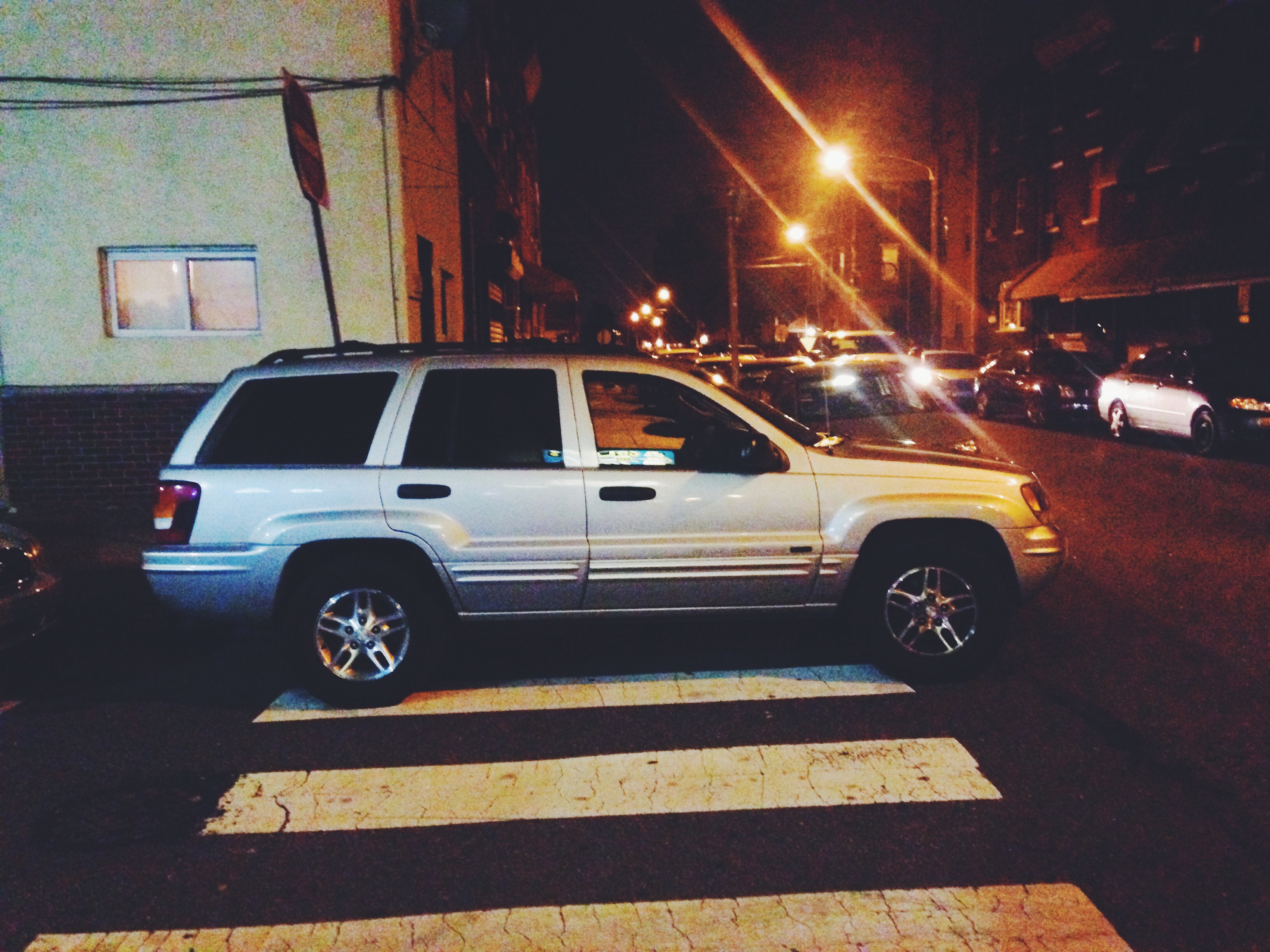 A car parked in a crosswalk. (Jon Geeting/PlanPhilly)
