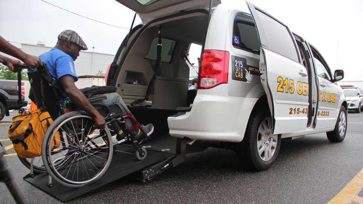 Tony Brooks tries out Philadelphia's new wheelchair accessible taxi in the parking lot of the Philadelphia Parking Authority's Taxicab and Limousine Division. (2015) | Emma Lee / WHYY