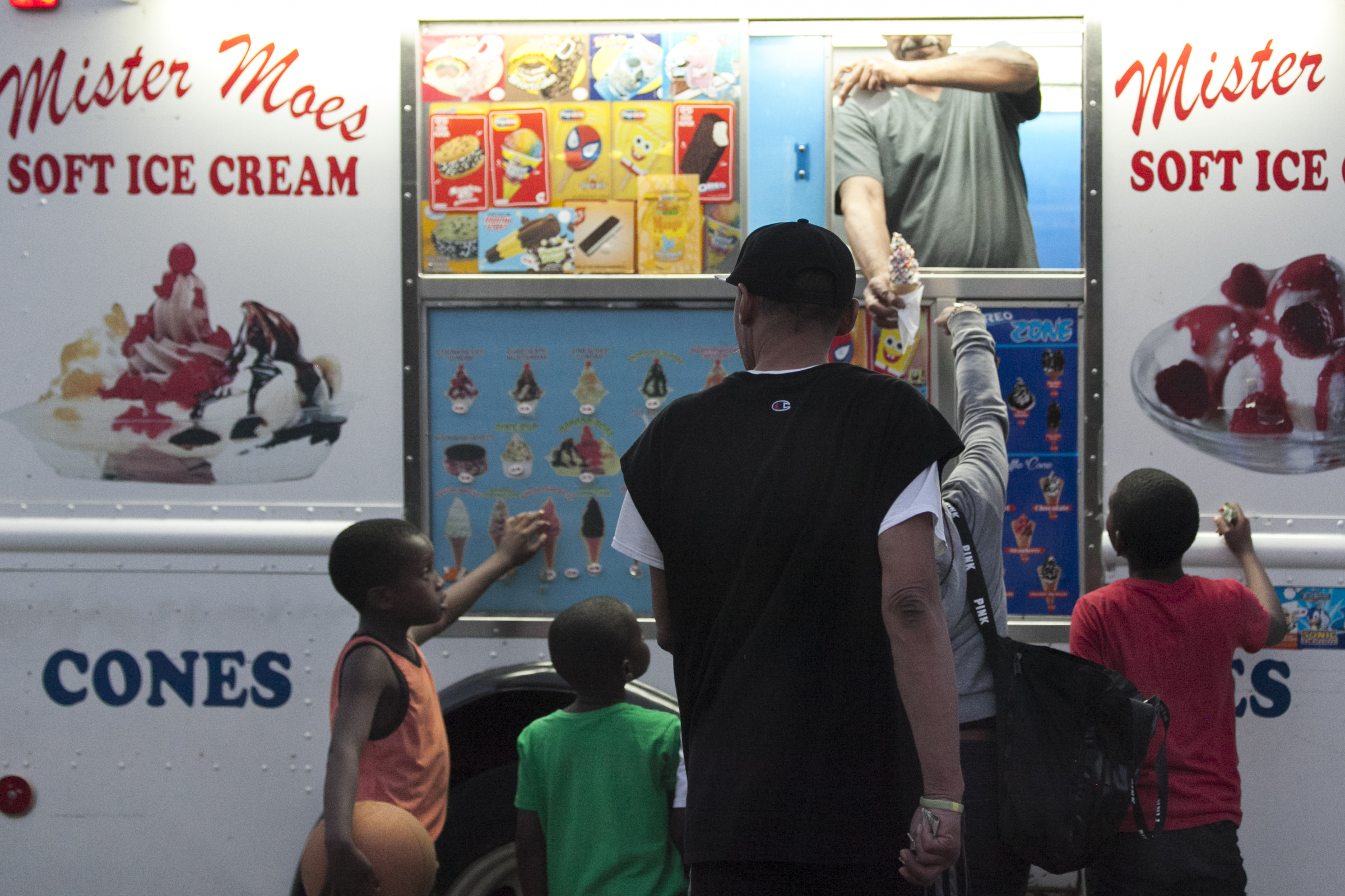 A family orders ice cream from Mister Moes Soft Ice Cream, parked on 10th Street on the evening of Wednesday, July 18, 2018. MAGGIE LOESCH
