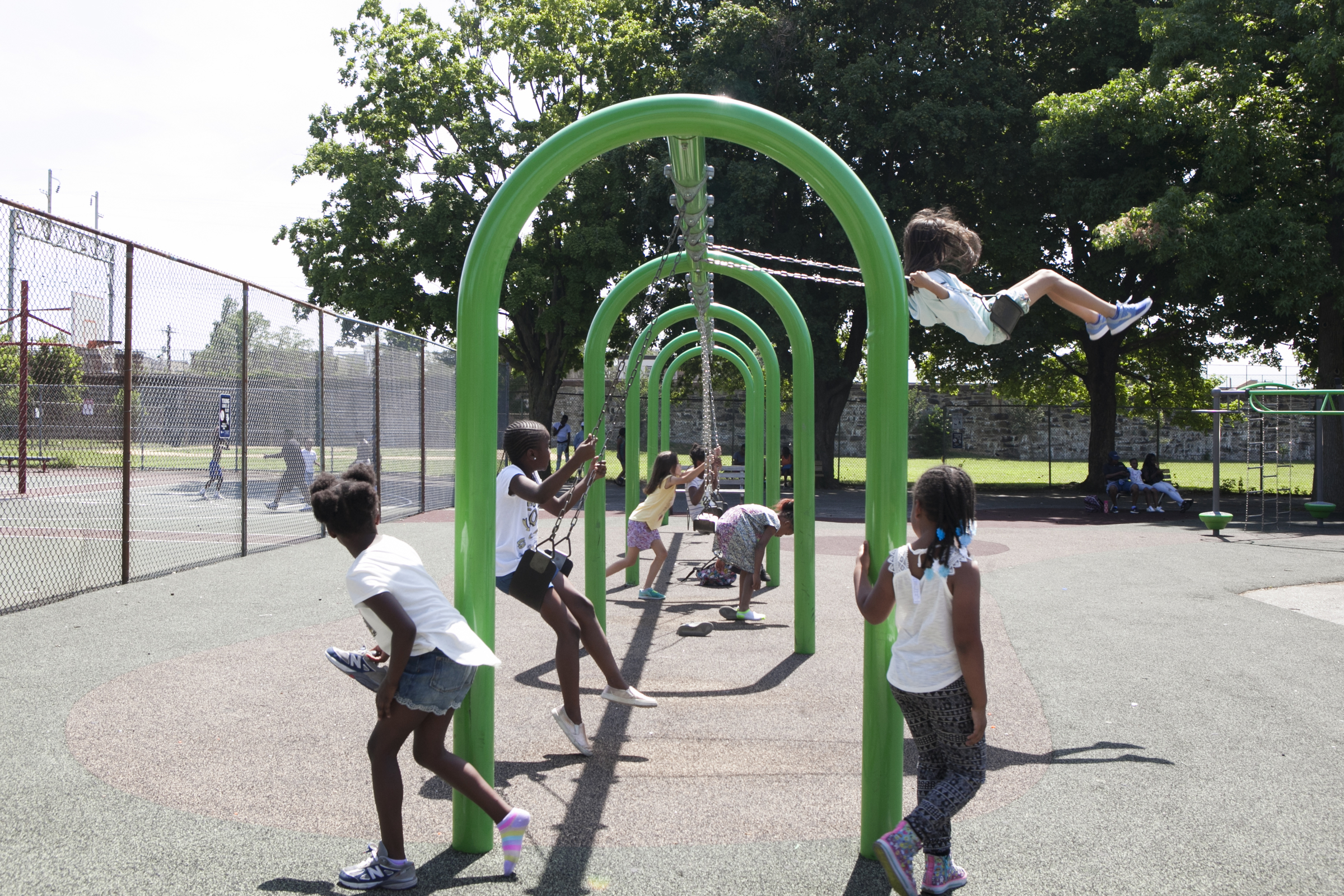 Camp kids play on the swings on the morning of June 29. | Maggie Loesch for PlanPhilly           