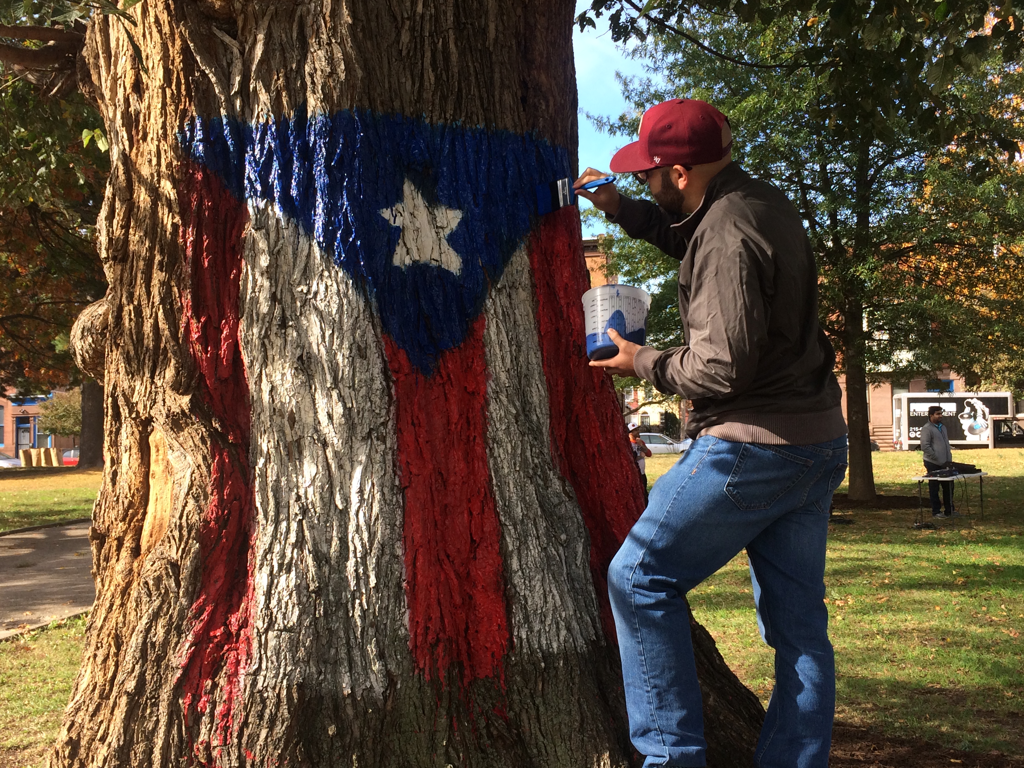 Philadelphia is actively helping rebuilt Puerto Rico. In the picture, man retouching Puerto Rican flag in Norris Square Park. 
