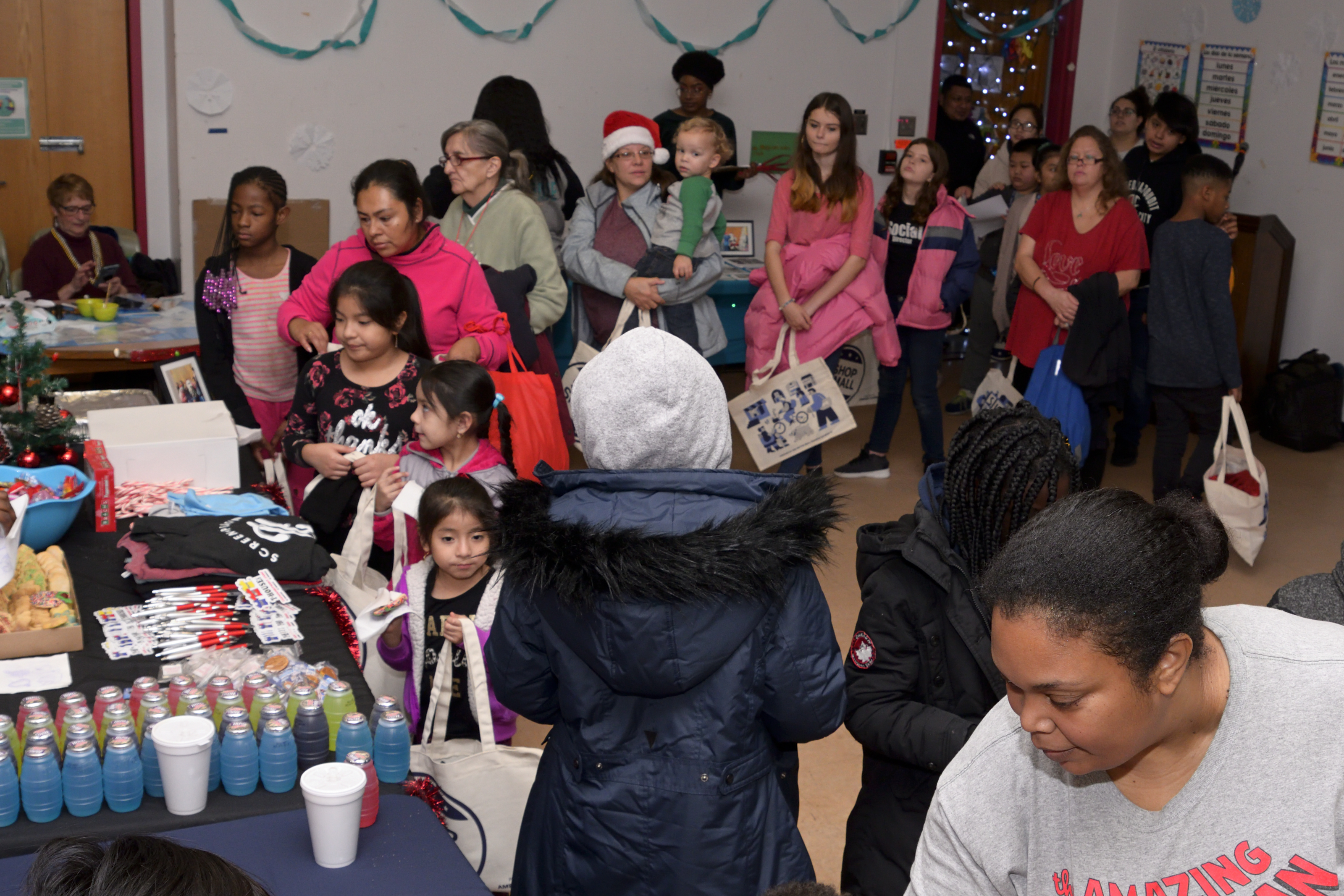Families line up for toys, snacks, and games at the Annual Winter Festival in Olney. Bas Slabbers/WHYY