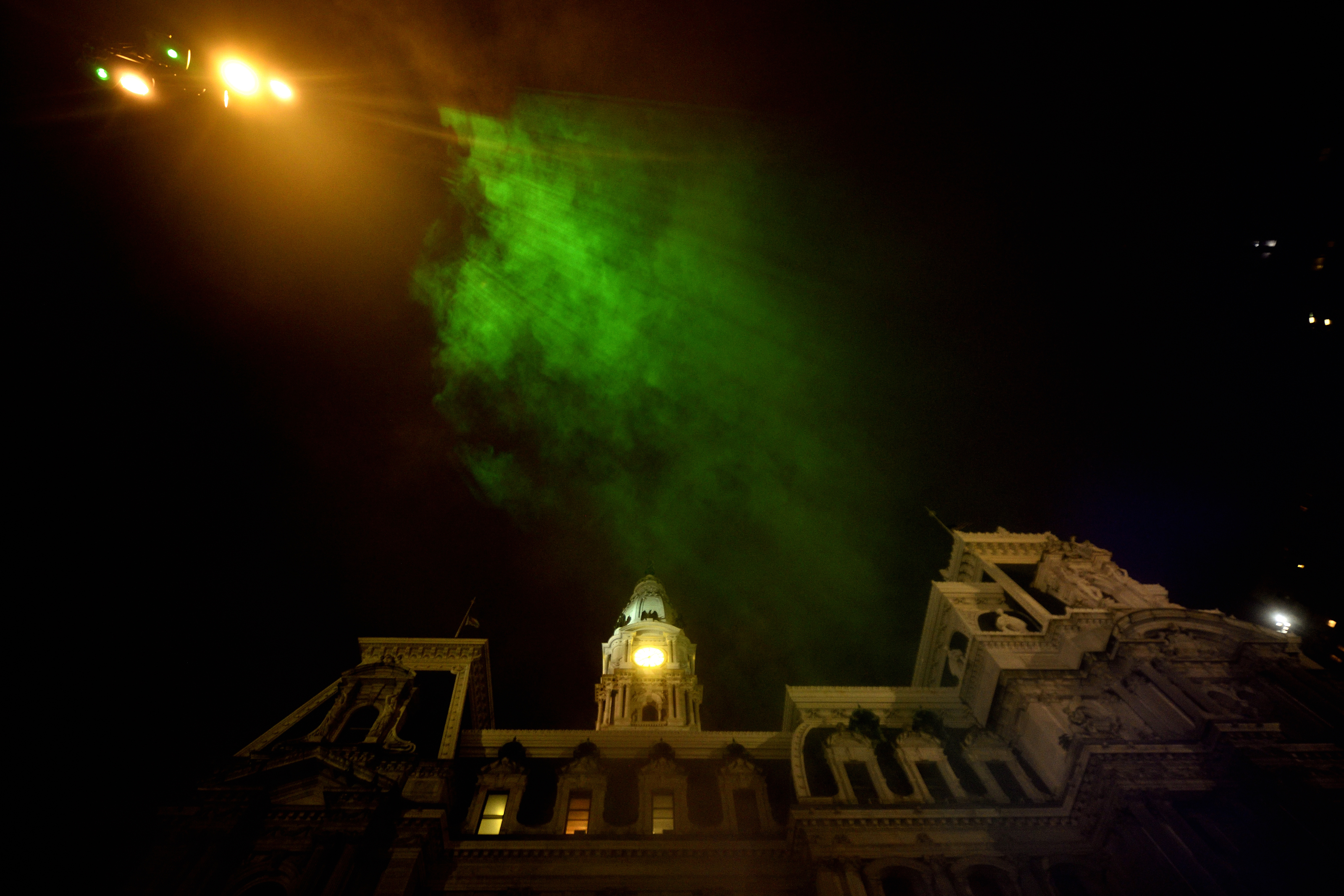 Mist catches green rays of light as it billows up towards the sky during the public unveiling of the first section of the site-specific art installation titled Pulse at the Dilworth Park’s fountain, on Wednesday. (Bastiaan Slabbers for WHYY)