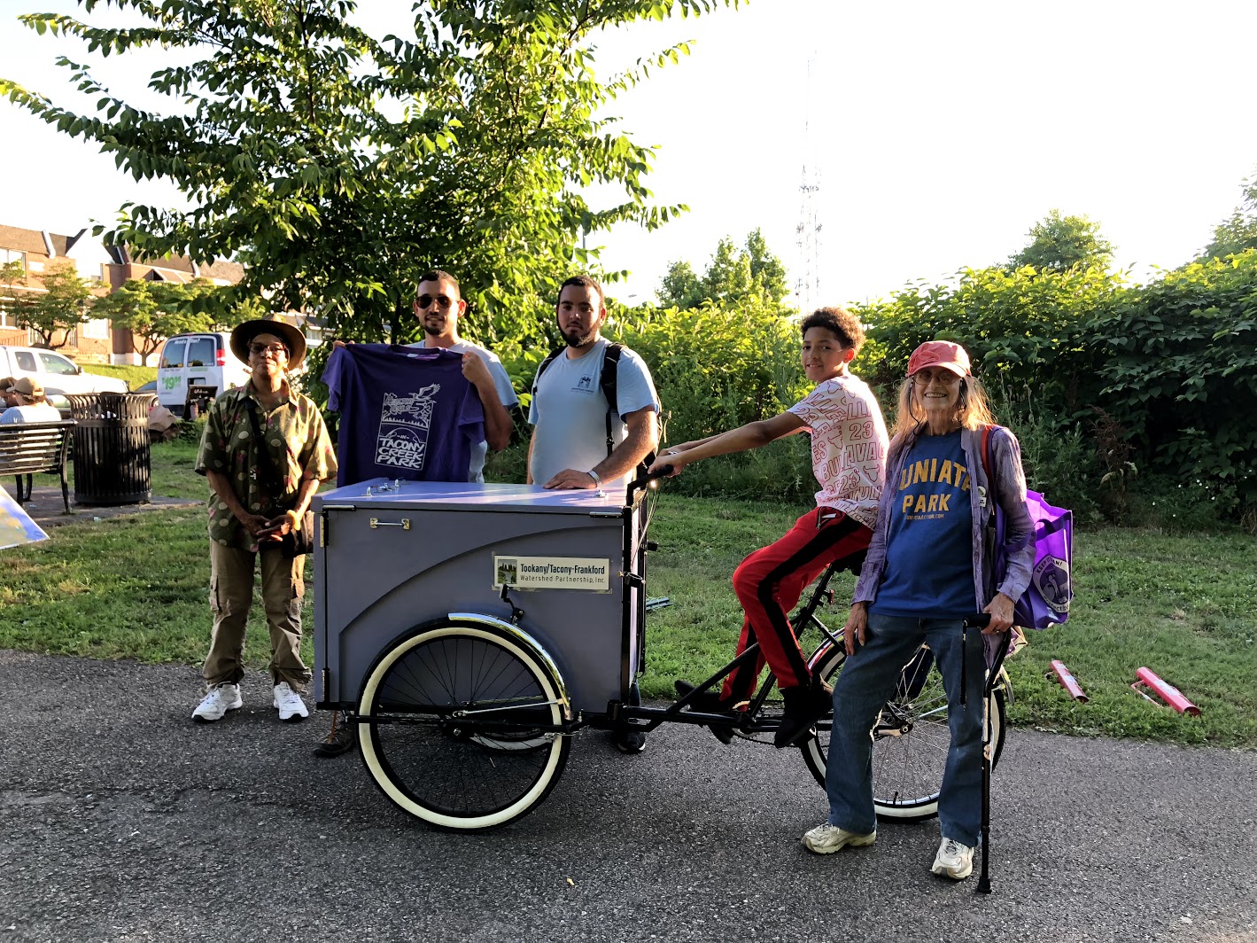 Multiple generations of friends and stewards of Tacony Creek Park, with the 'Creek Mobile.' Credit: Diana Lu/WHYY