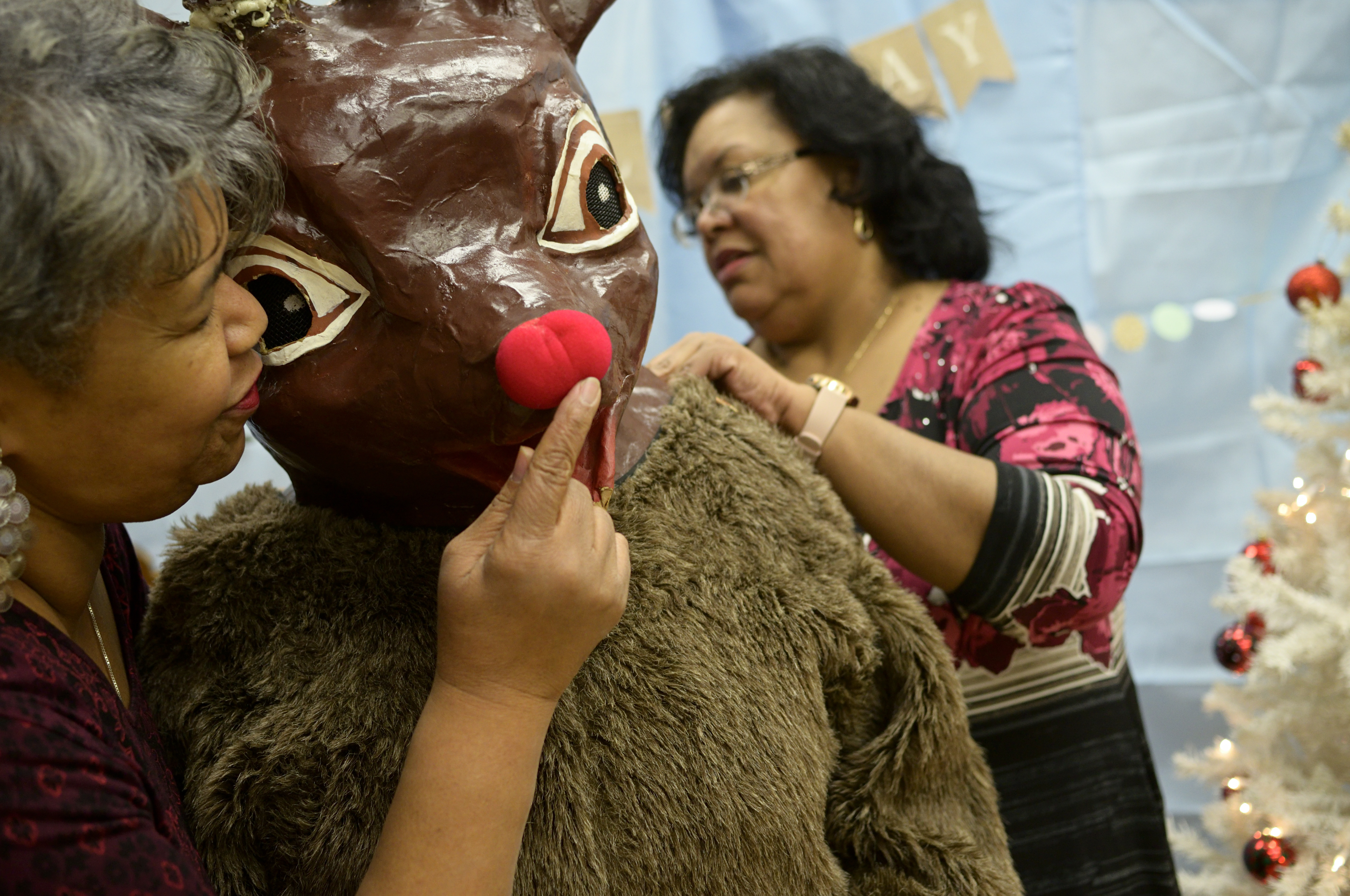 Staff members from Councilwoman Parker's office help prep Rudolph for the Annual Winter Festival in Olney. Bas Slabbers/WHYY.