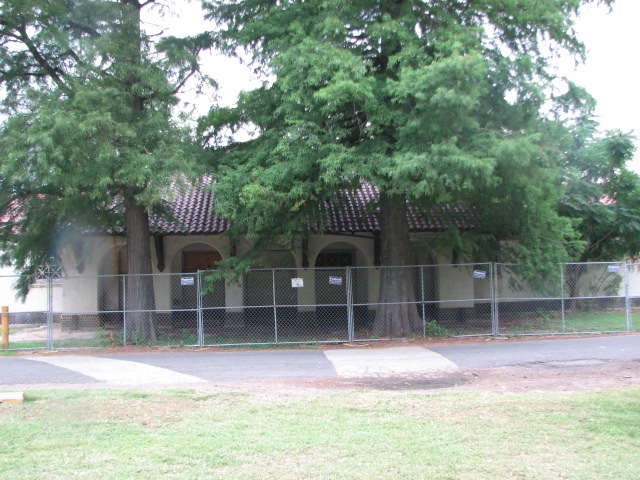 Much of the building is now hidden by trees and overgrowth.