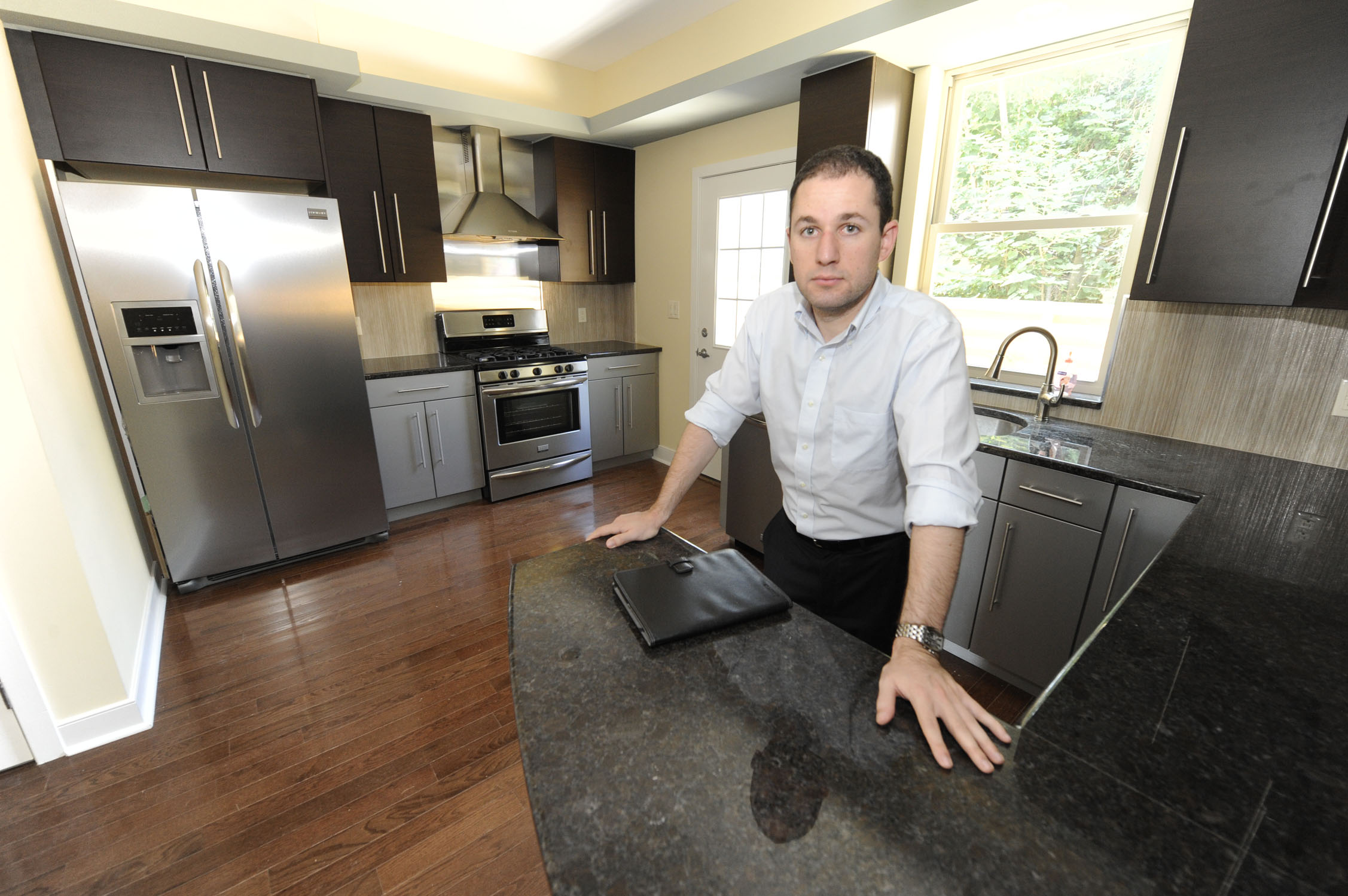Developer Feibush in a townhome built on a tax delinquent lot he purchased at sheriff sale. (Clem Murray/ Inquirer)