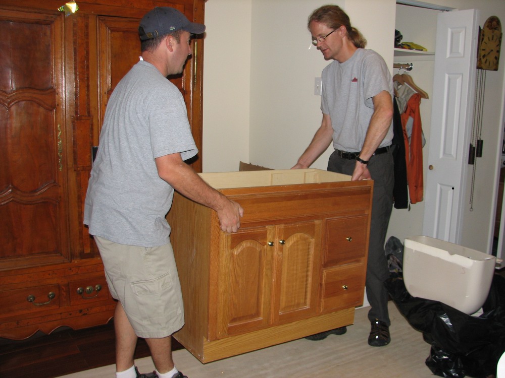 Donor Johannes Reiser helps volunteer Don Liberati move a bathroom vanity
