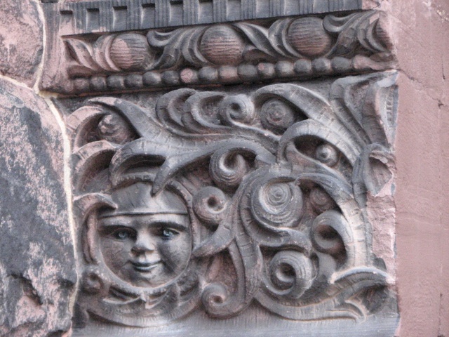 Flames spiral around a face carved on Engine House No. 29.