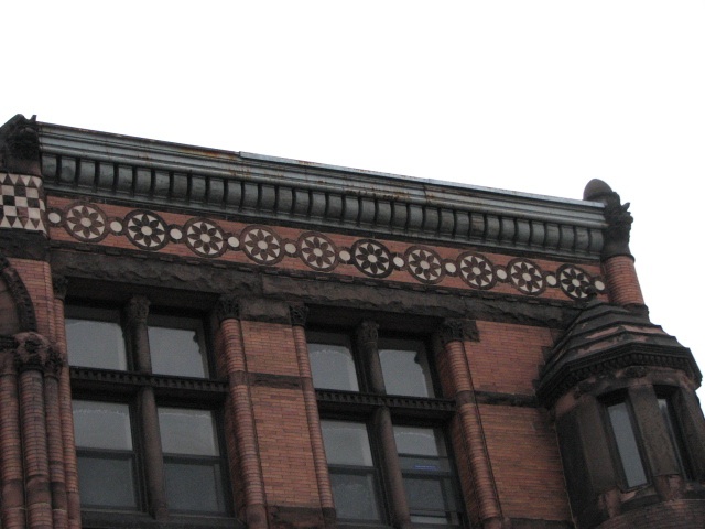 Floral roundels appear again along the roof line.