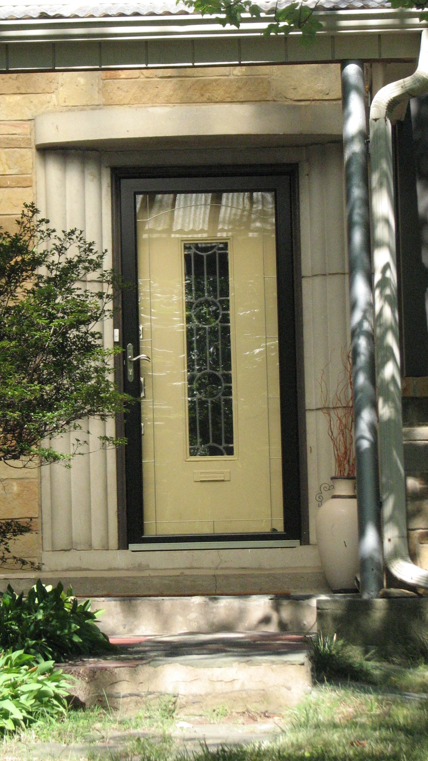 The Art Deco-style portico and line-and-circle glass design have survived on several homes.
