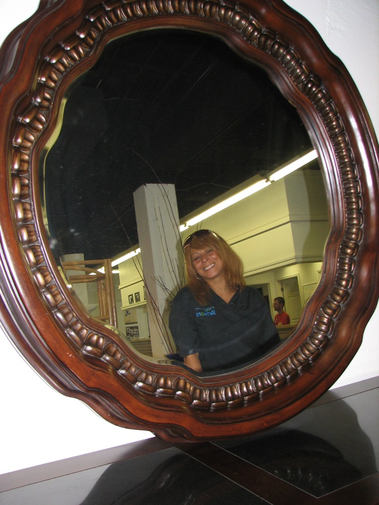 Habitat ReStore Director Gail Lankford, reflected in a dresser's mirror