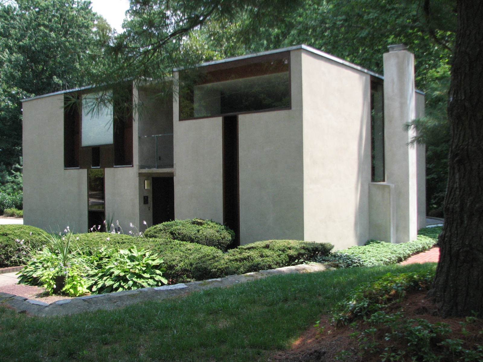 The front of the Margaret Esherick House allows light through two T-shaped windows.
