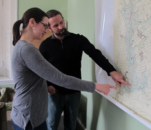 Maura McCarthy, executive director of the FOW, and Kevin Groves, volunteer coordinator, look at a map of the Wissahickon