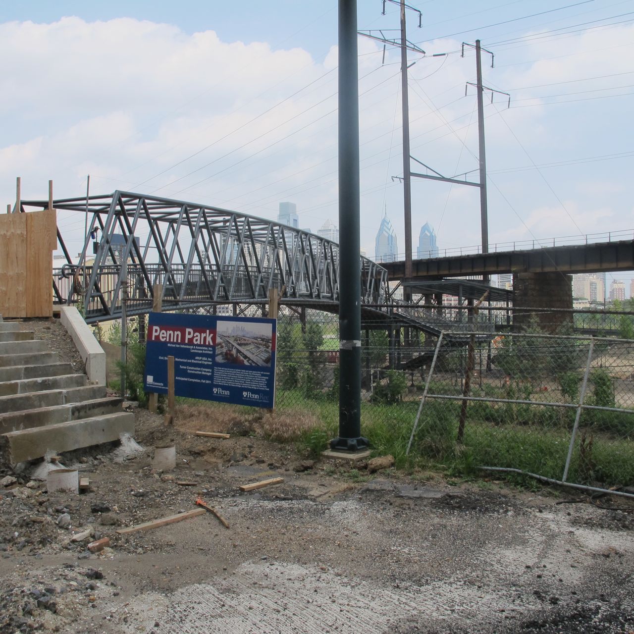 A sign naming the site with Paley Bridge Extension in background