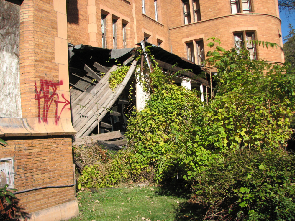 The front porch of the Nugent building collapsed after supporting columns were stolen.