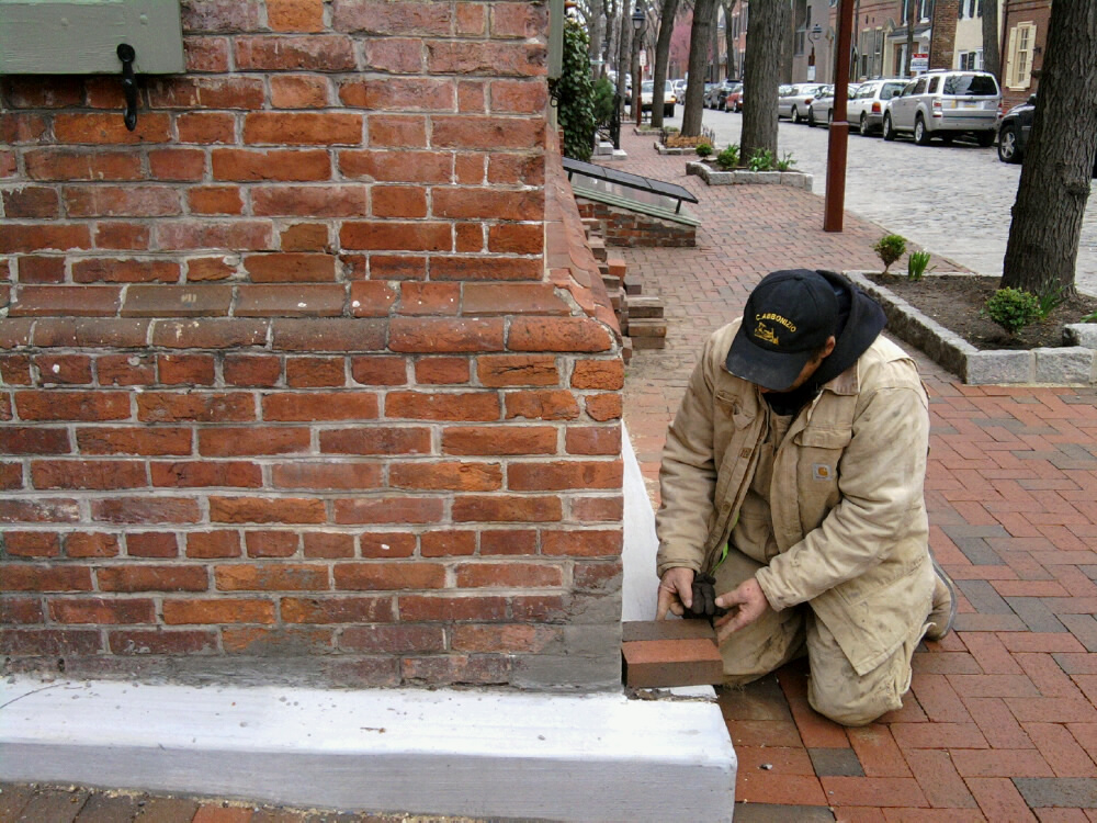 A supervisor shows how a cheek wall could be faced with brick