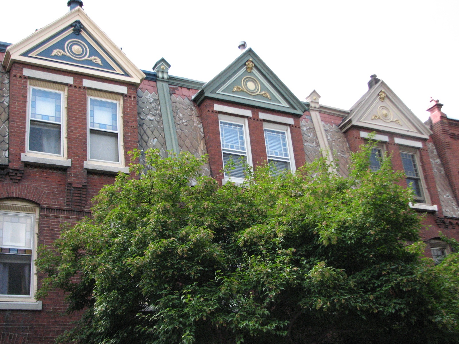 Fancy gables and sloping shingles stand out on the west side of Woodstock Street.