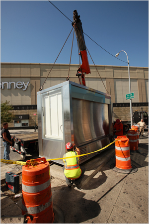 James Estrin/The New York Times / One of the new CEMUSA newsstands was installed last week near the Queens Center mall. 