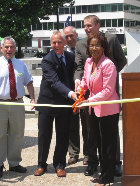 Ash, Dambman, and Reynolds Brown, joined by others who helped in achieving the new legislation, cut the ribbon